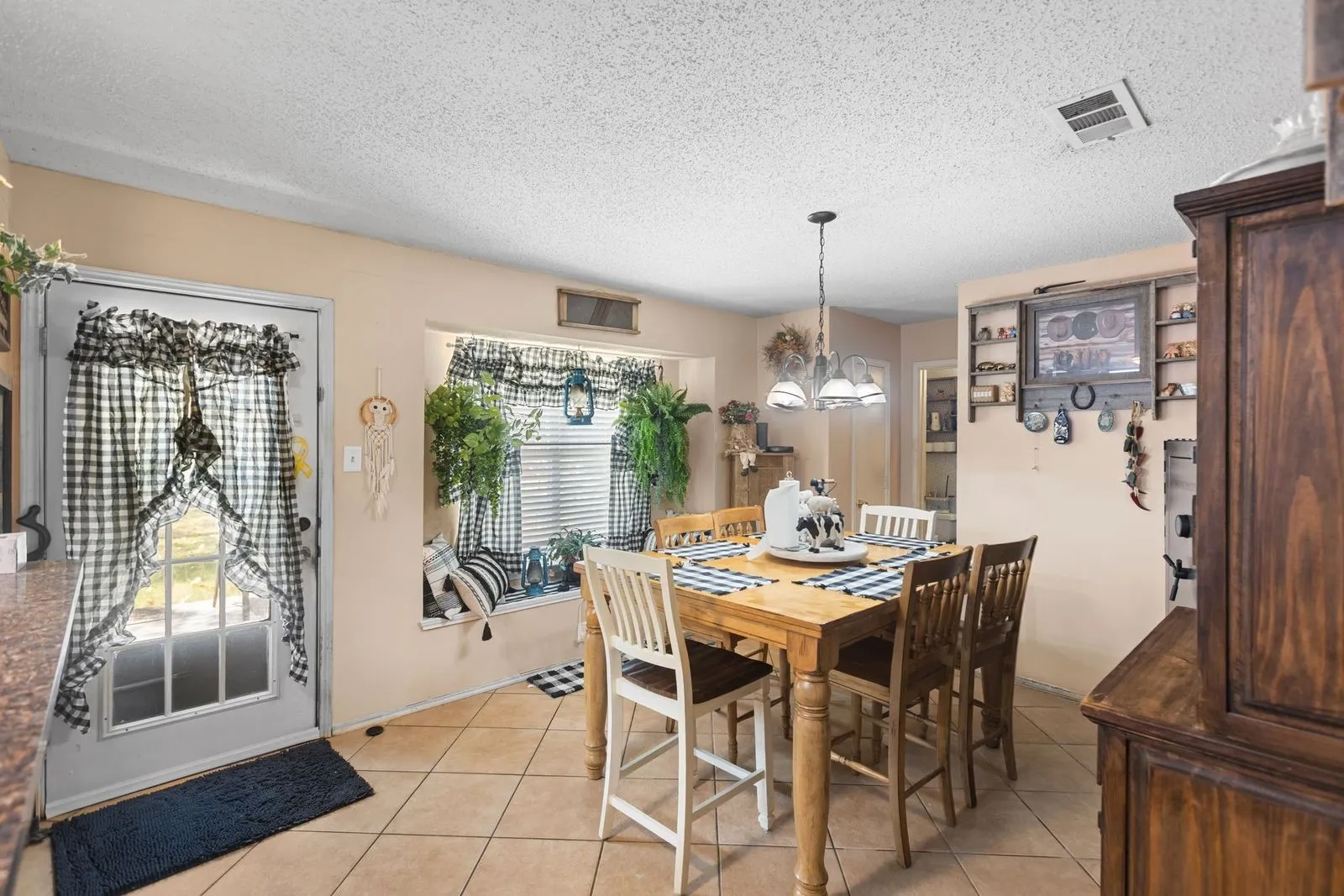 Tile flooring, built-in window seating, recessed window, and pendant lighting