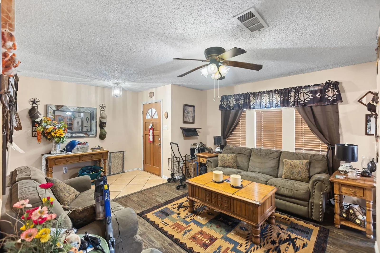 Wood-finish flooring, tiled entry, ceiling fan, natural light, and recessed lighting