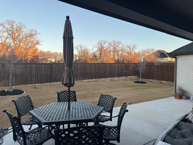 All fenced in backyard with large patio