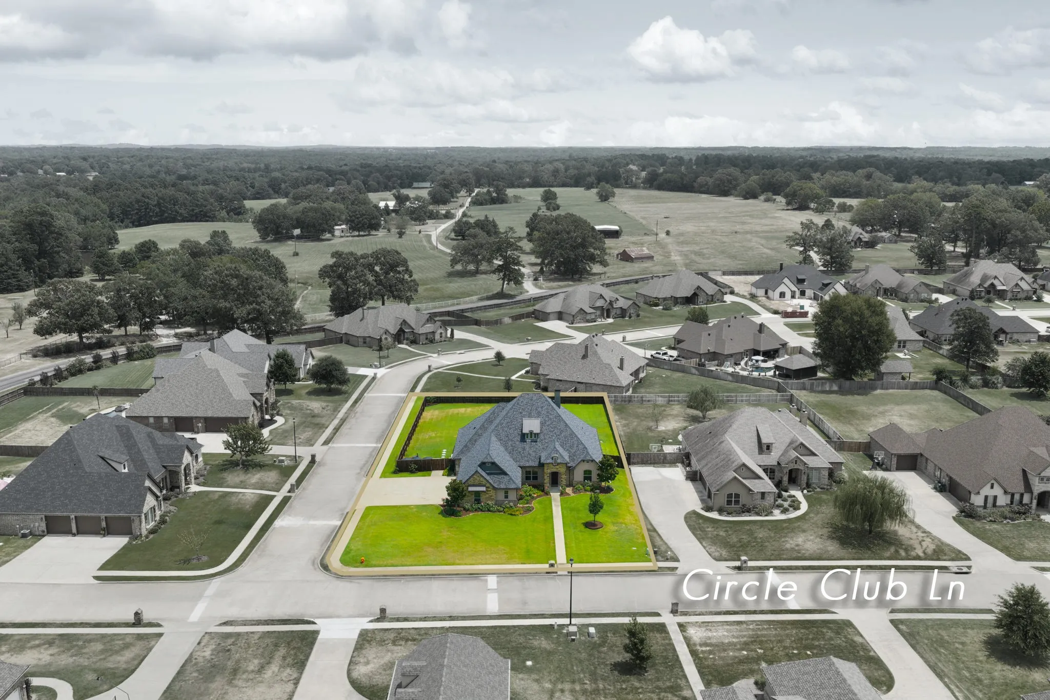 Residential property on a paved street with a manicured lawn and a treed backdrop