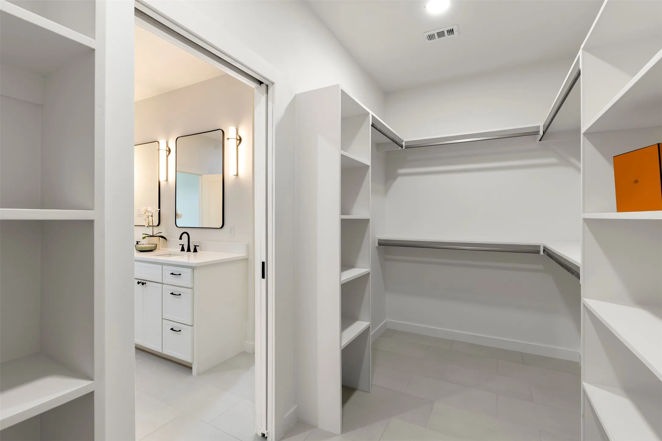 Walk-in closet with built-in shelving and hanging rods