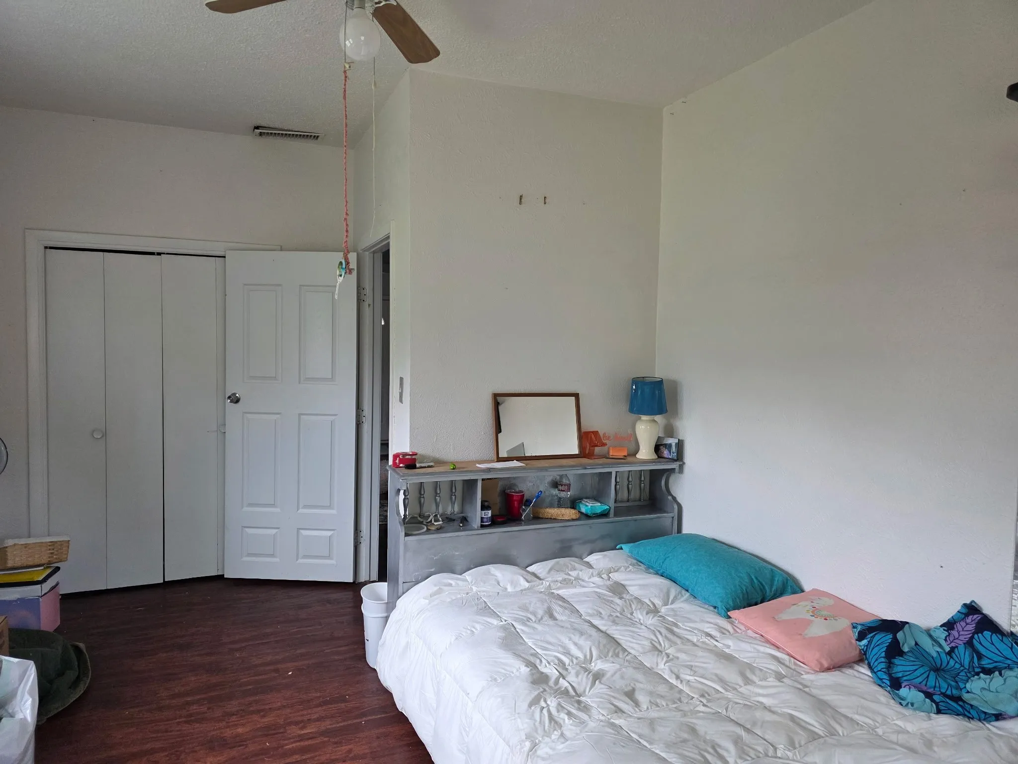 Bedroom featuring wood finished floors, a closet, ceiling fan, and a textured ceiling