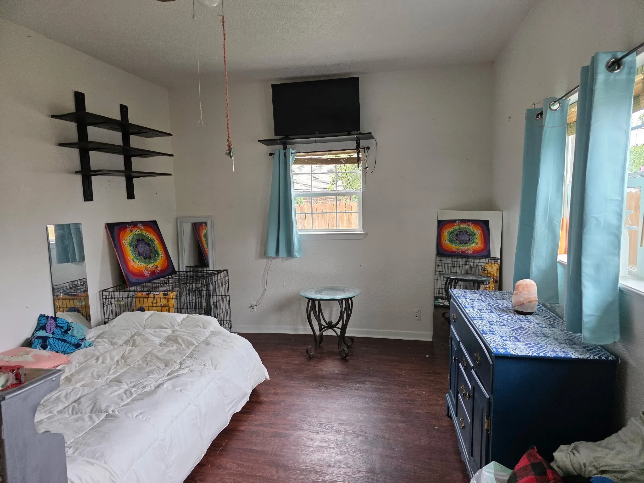 Bedroom with dark wood-style floors and baseboards