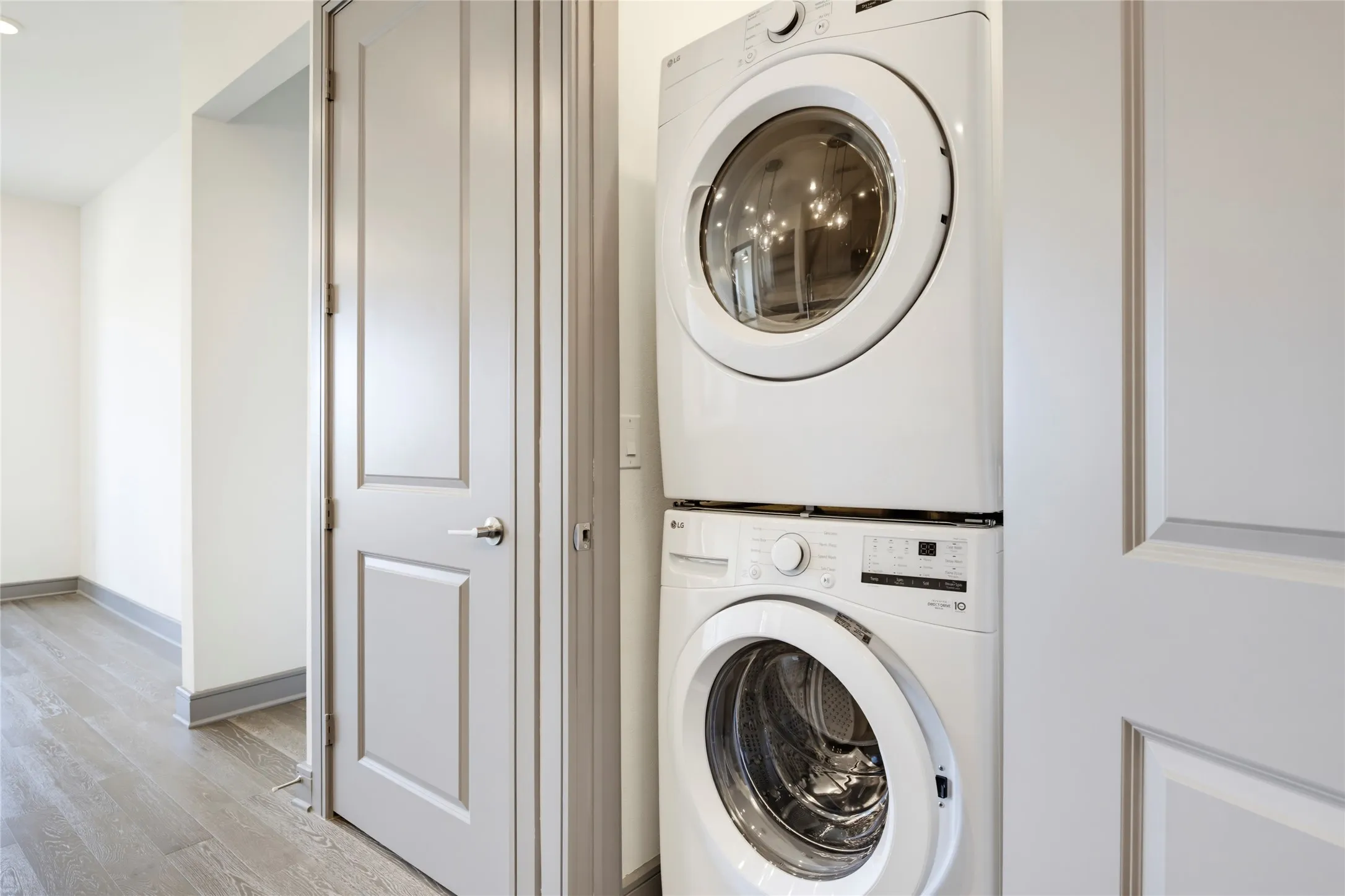 Stackable washer and dryer appliances, panel doors, and wood-finish flooring