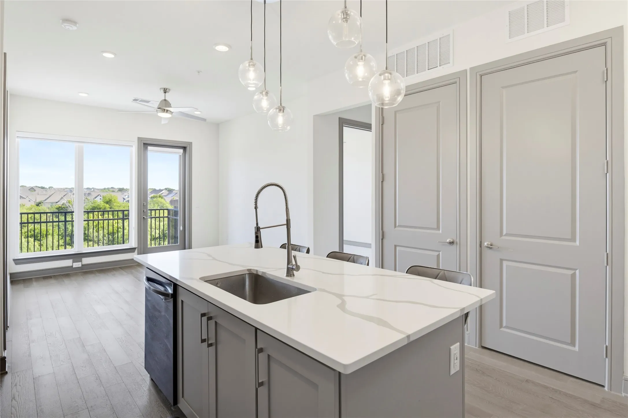 Kitchen island with stone-finish countertop and undermount sink