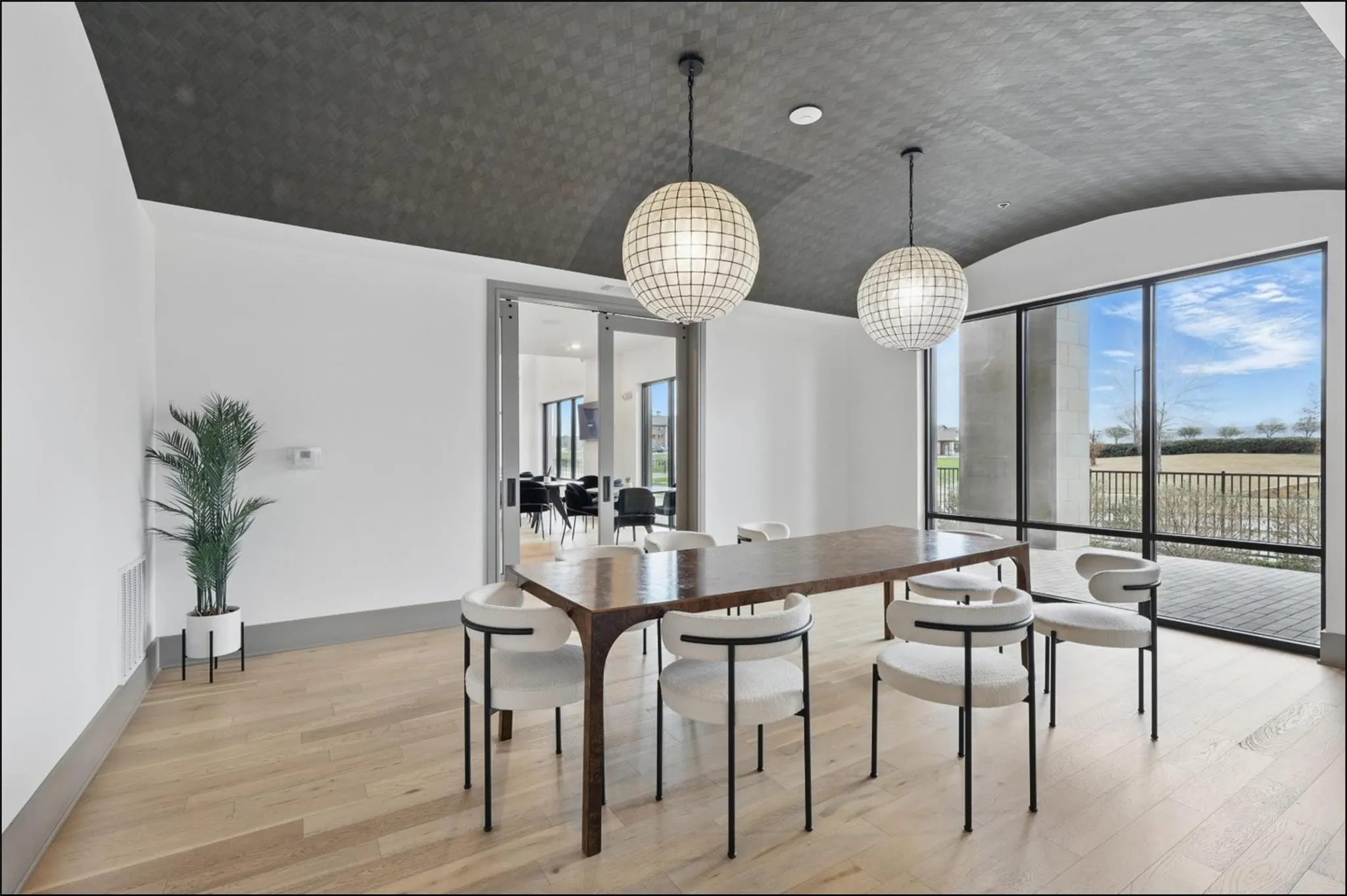 Light wood-finish flooring with a dark gray baseboard