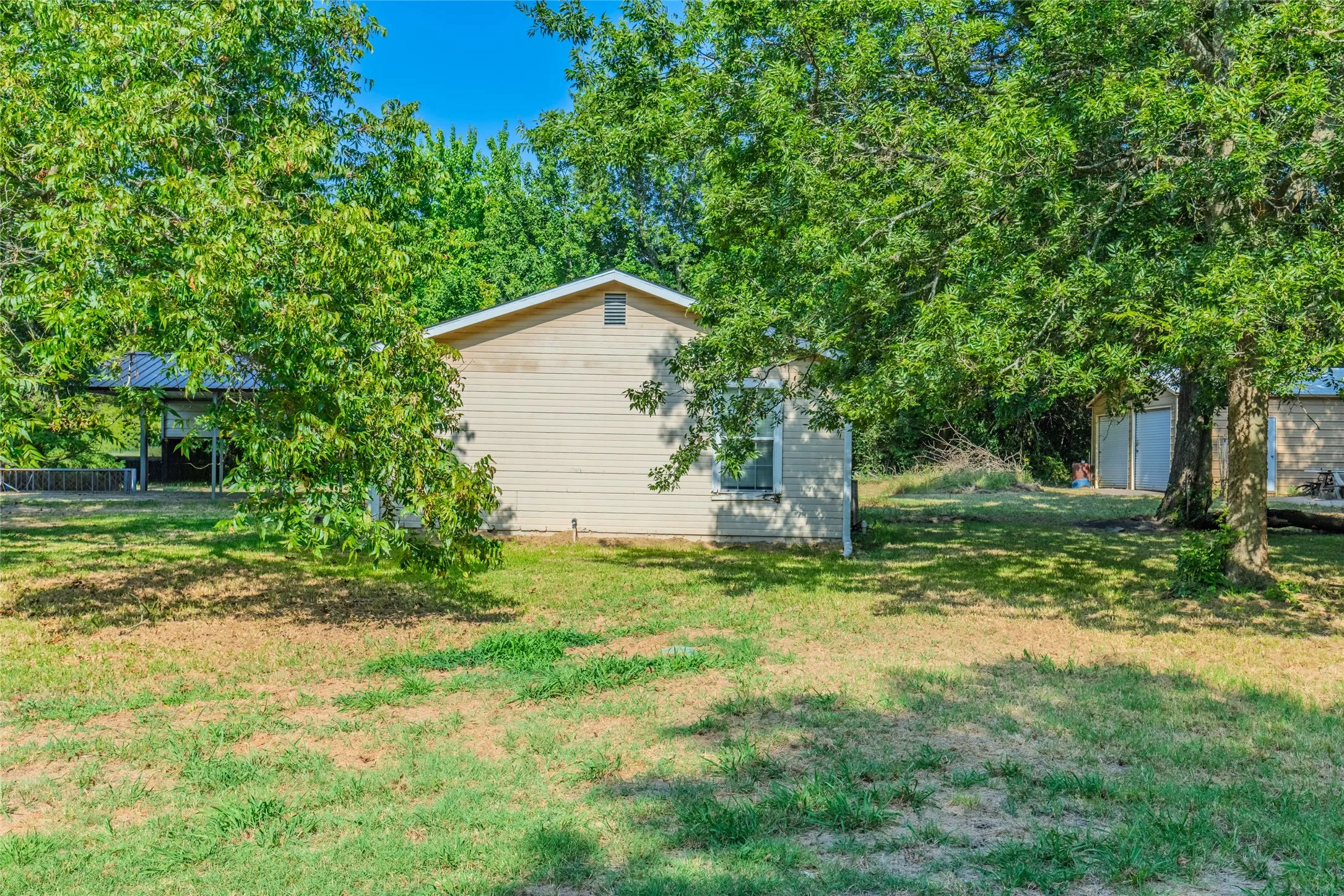 Charming residence situated on a spacious lot with mature shade trees and expansive grounds