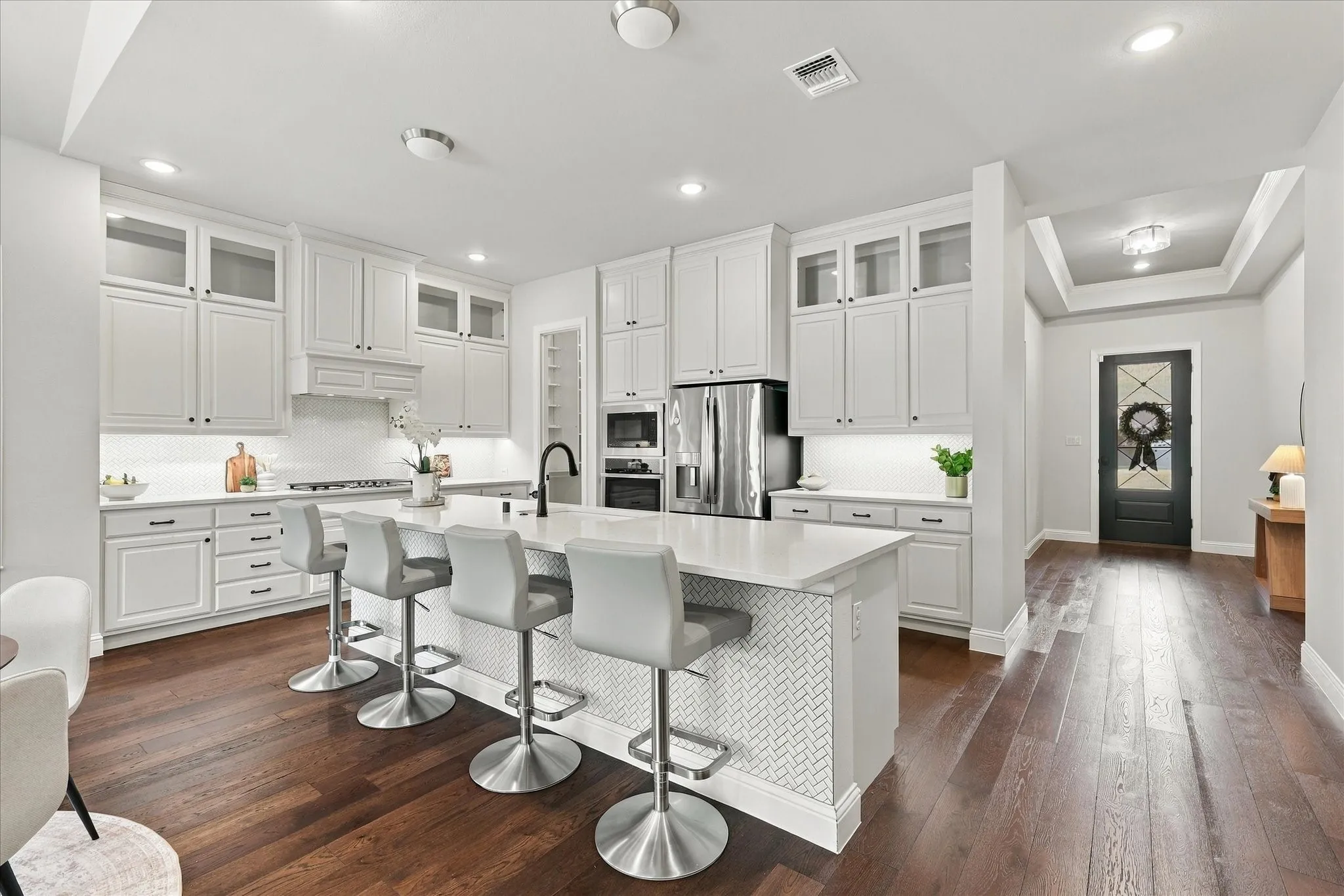 Cabinets to the ceiling provide excellent storage.  The glass fronts provide beautiful display space.