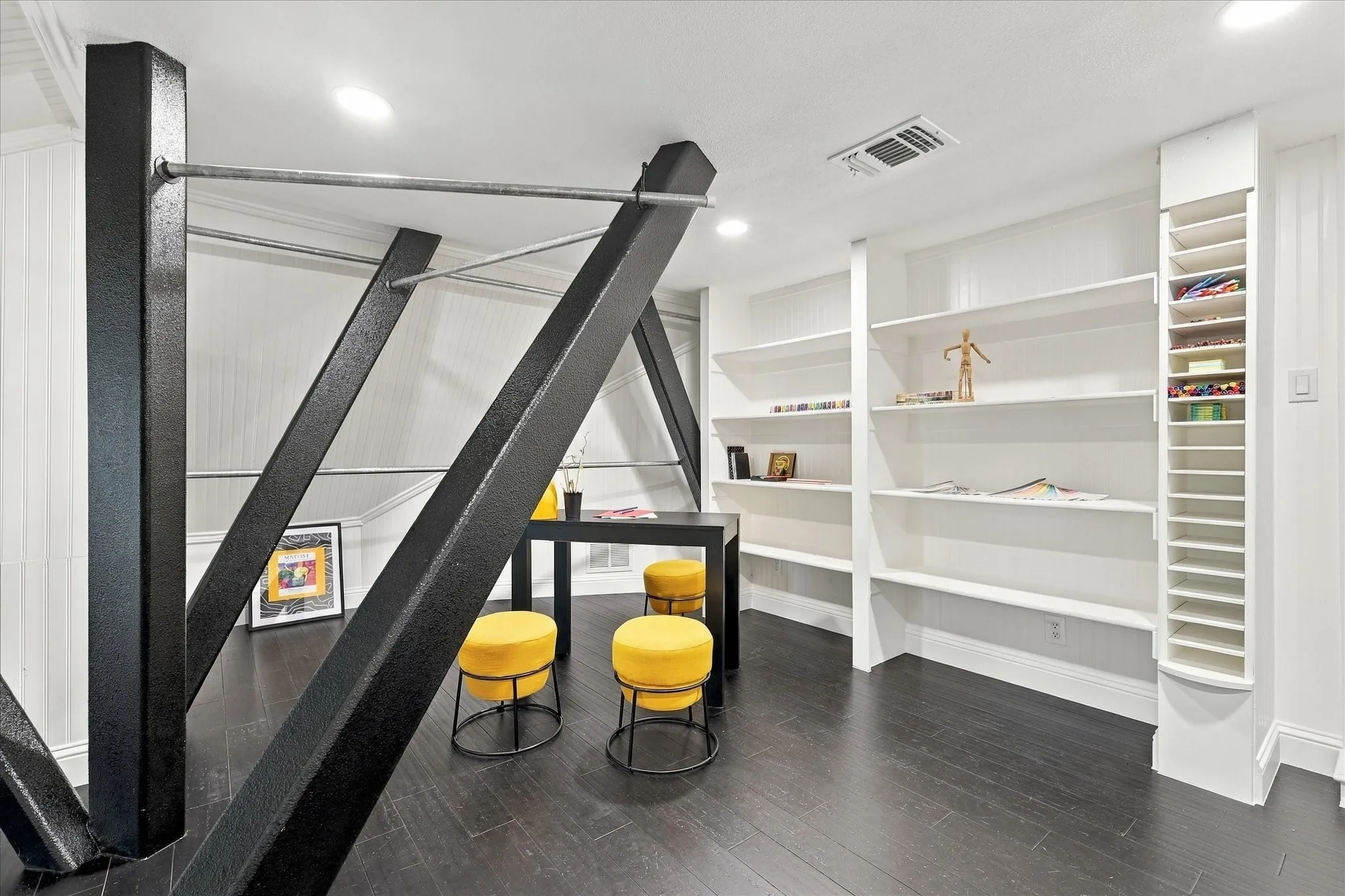 This space within the attic is charming and comfortable!  Two dormer windows give outside views and the interior is finished out with organized storage in mind!