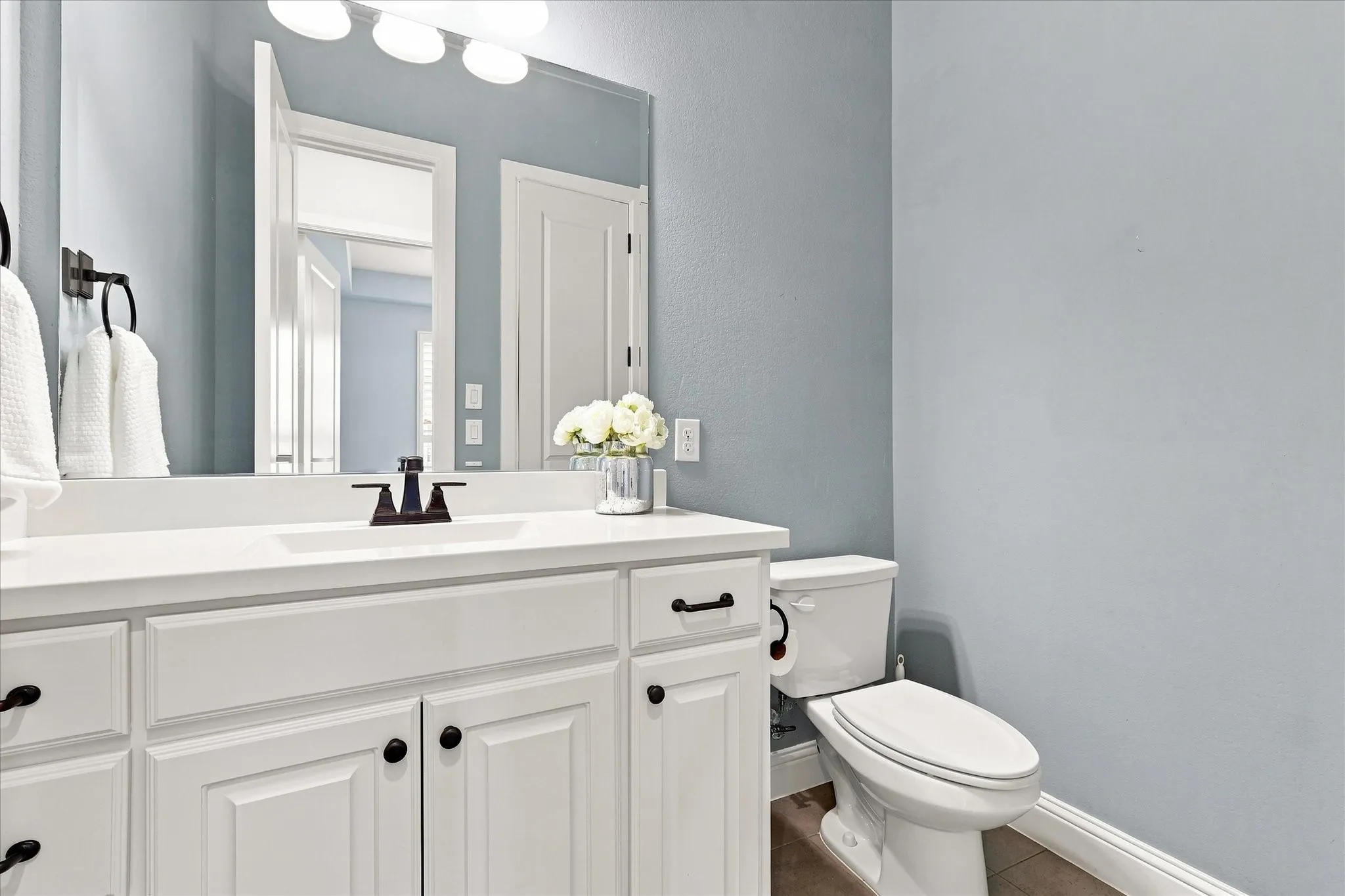 Powder bathroom at the front of the house services guests and the home office