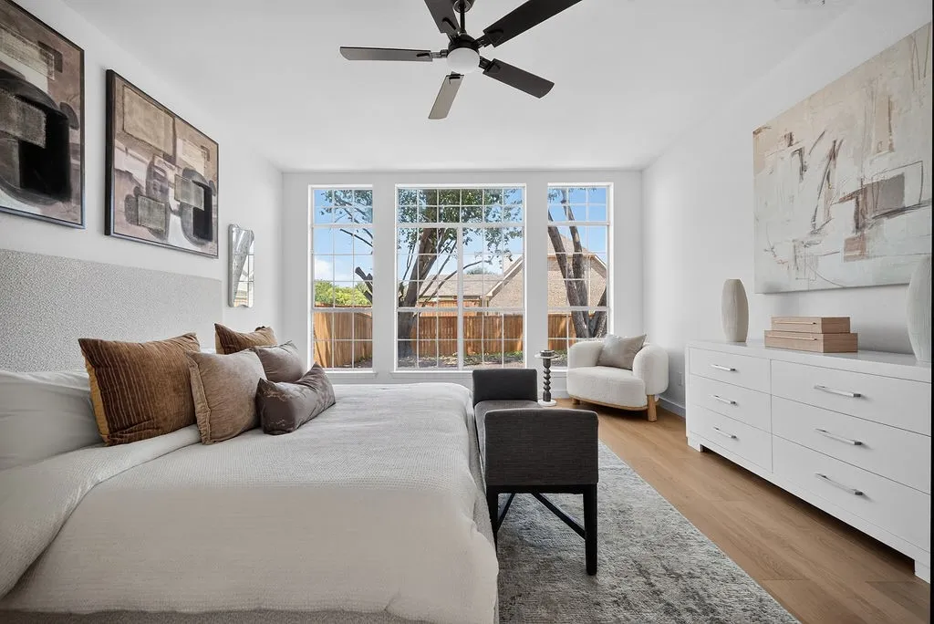 Bright interior with light wood-finish flooring and a ceiling fan