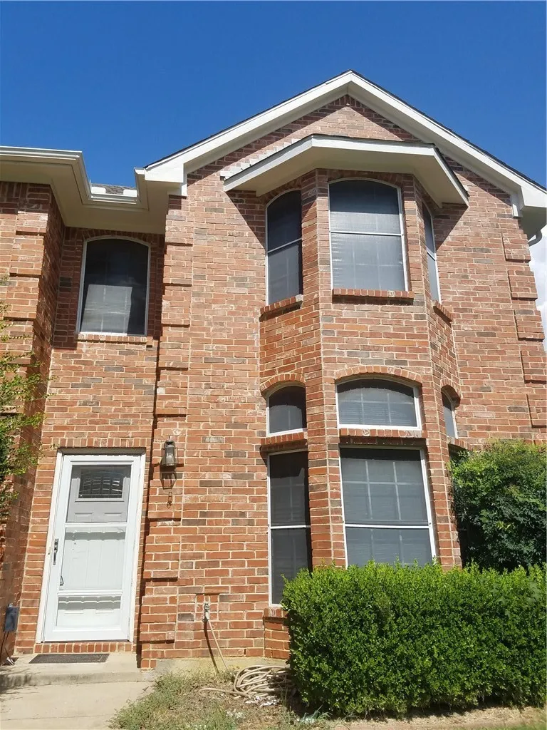 Beautiful two-story brick home features screens to help keep the house cool