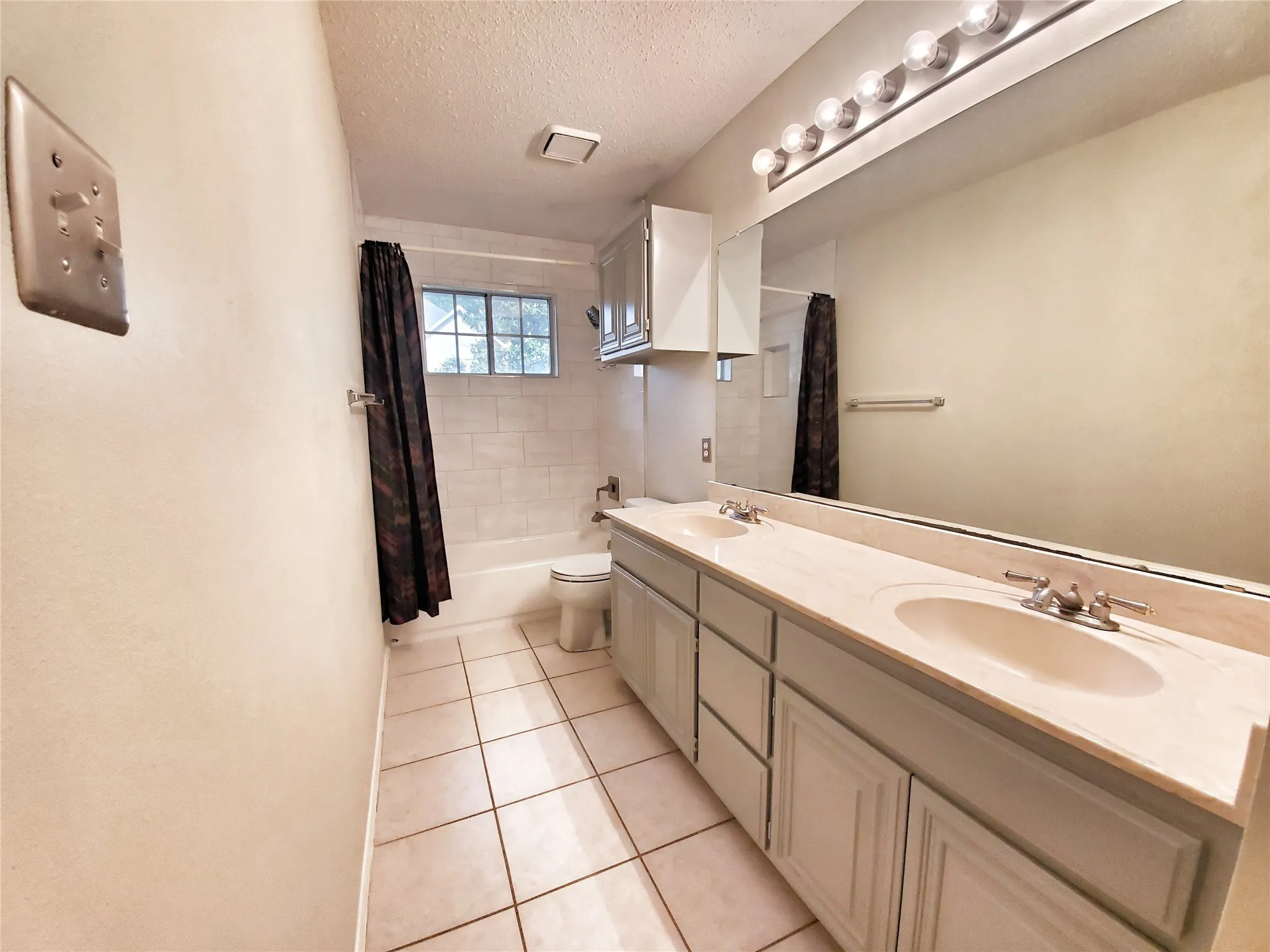 Full guest bathroom upstairs has plenty of counter and cabinet space.