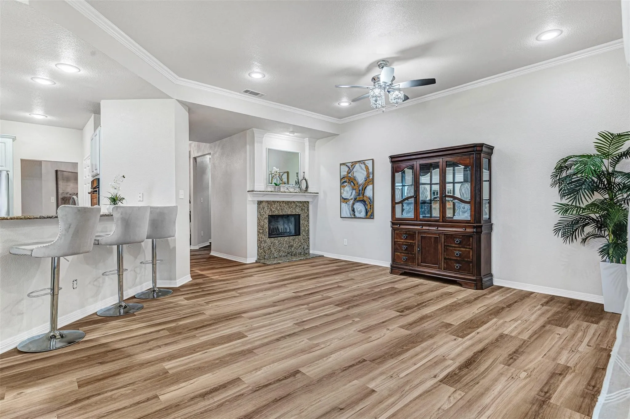 Vaulted ceiling with crown molding and recessed lighting