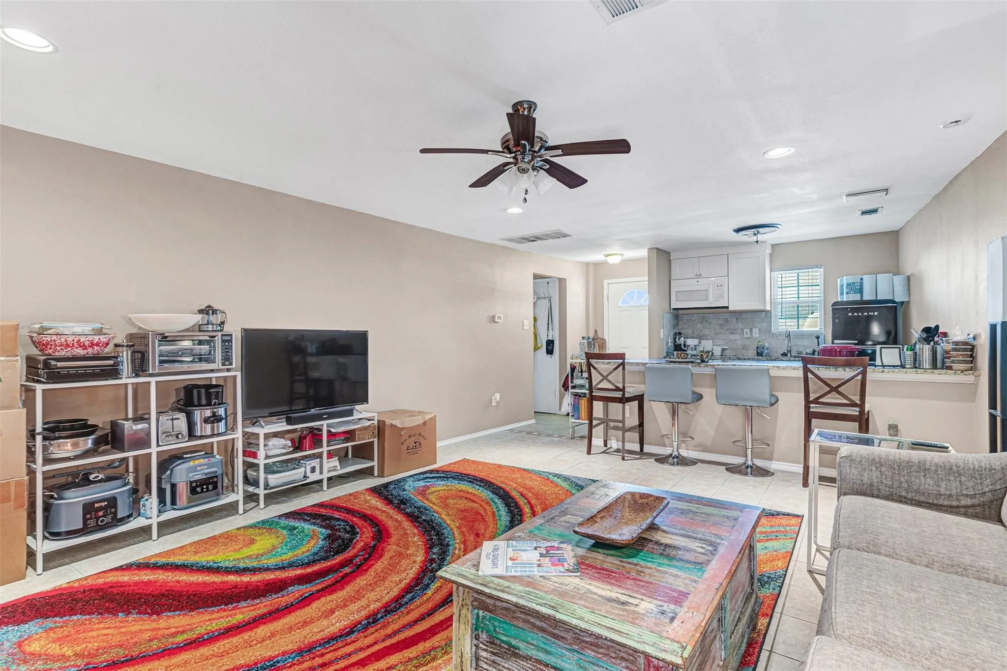 Open concept living area featuring recessed lighting, a ceiling fan, and tile flooring