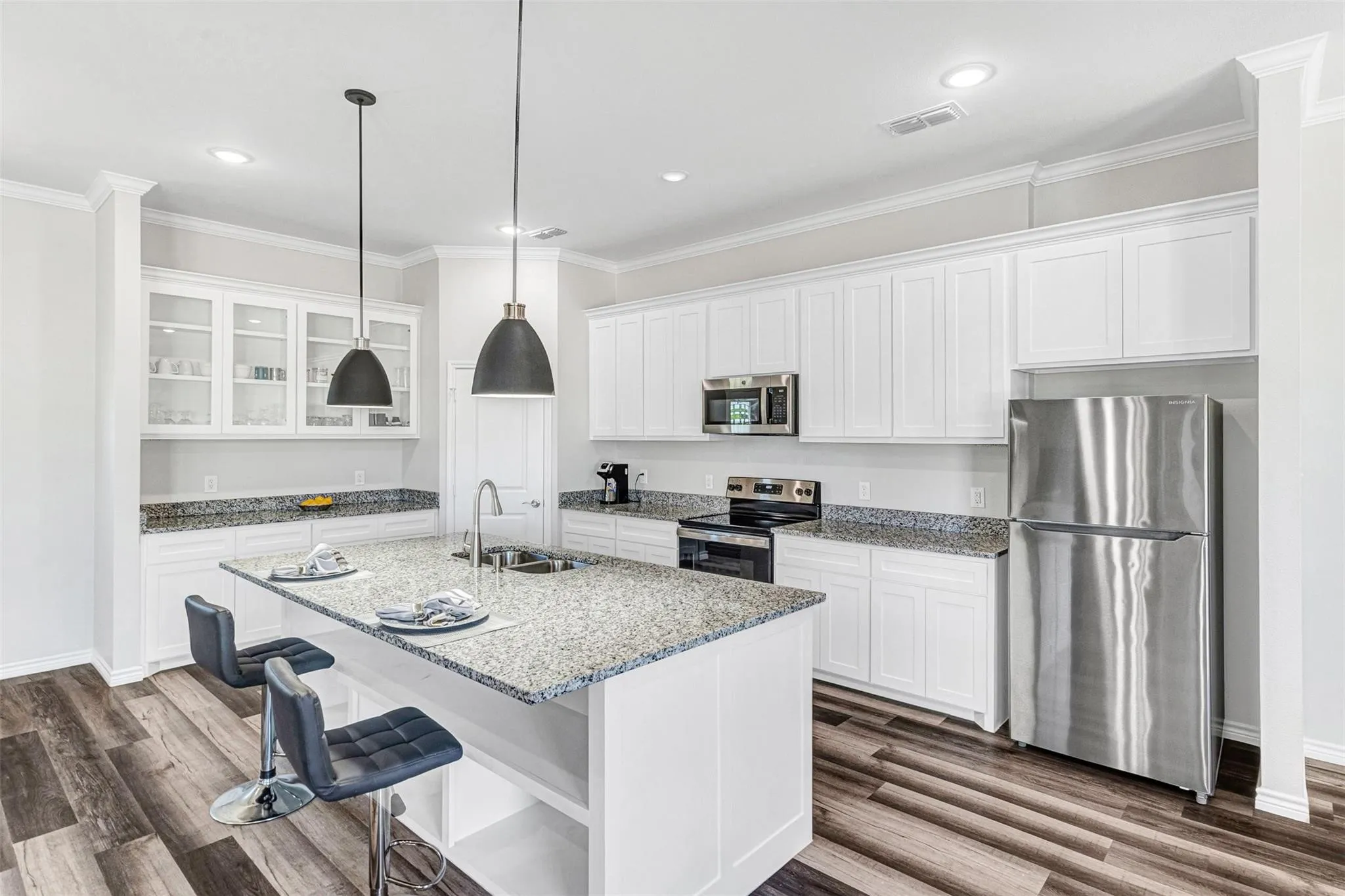 Kitchen featuring white cabinetry, granite countertops, stainless steel appliances, wood-finish flooring, and recessed lighting