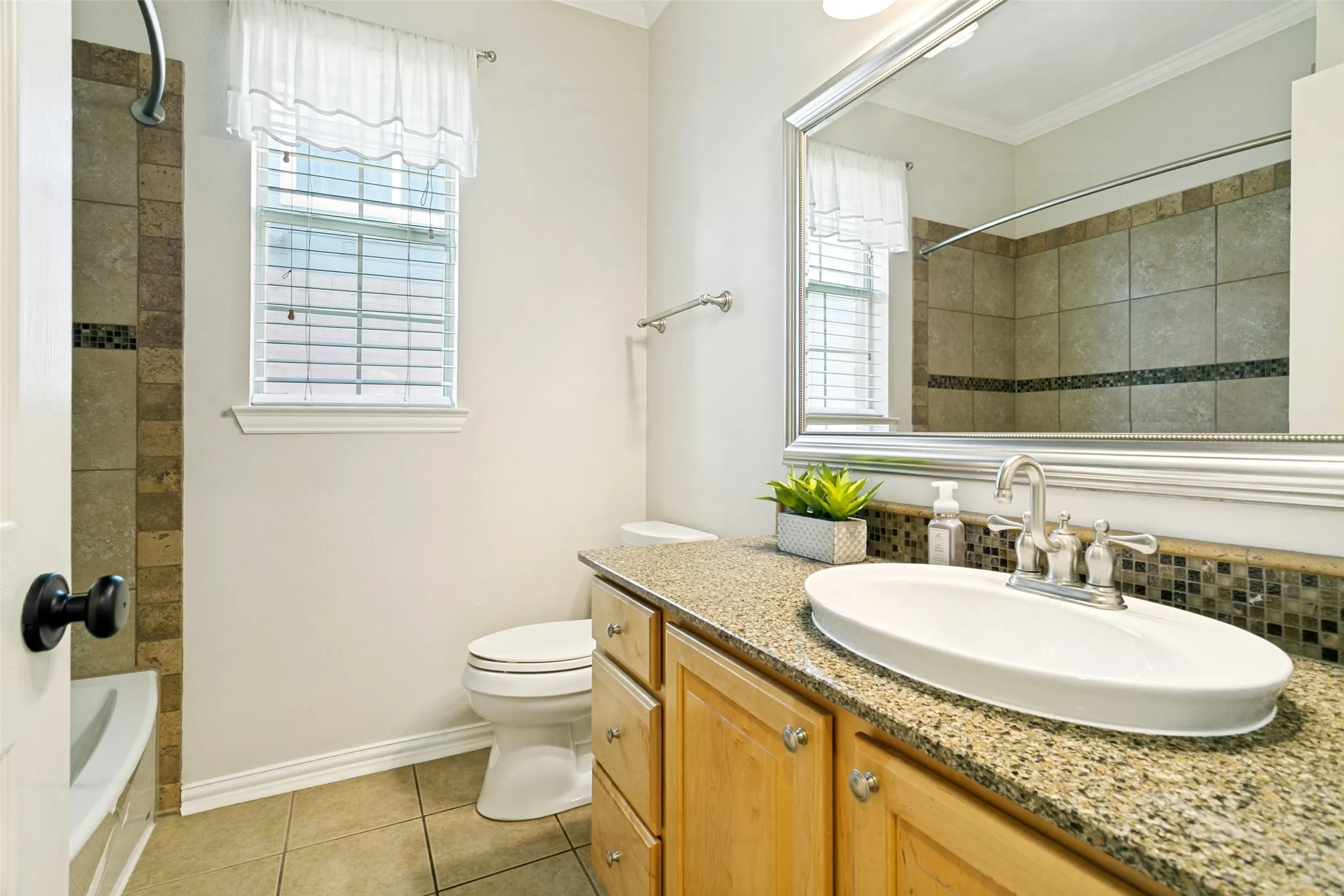 Guest bathroom featuring granite countertops
