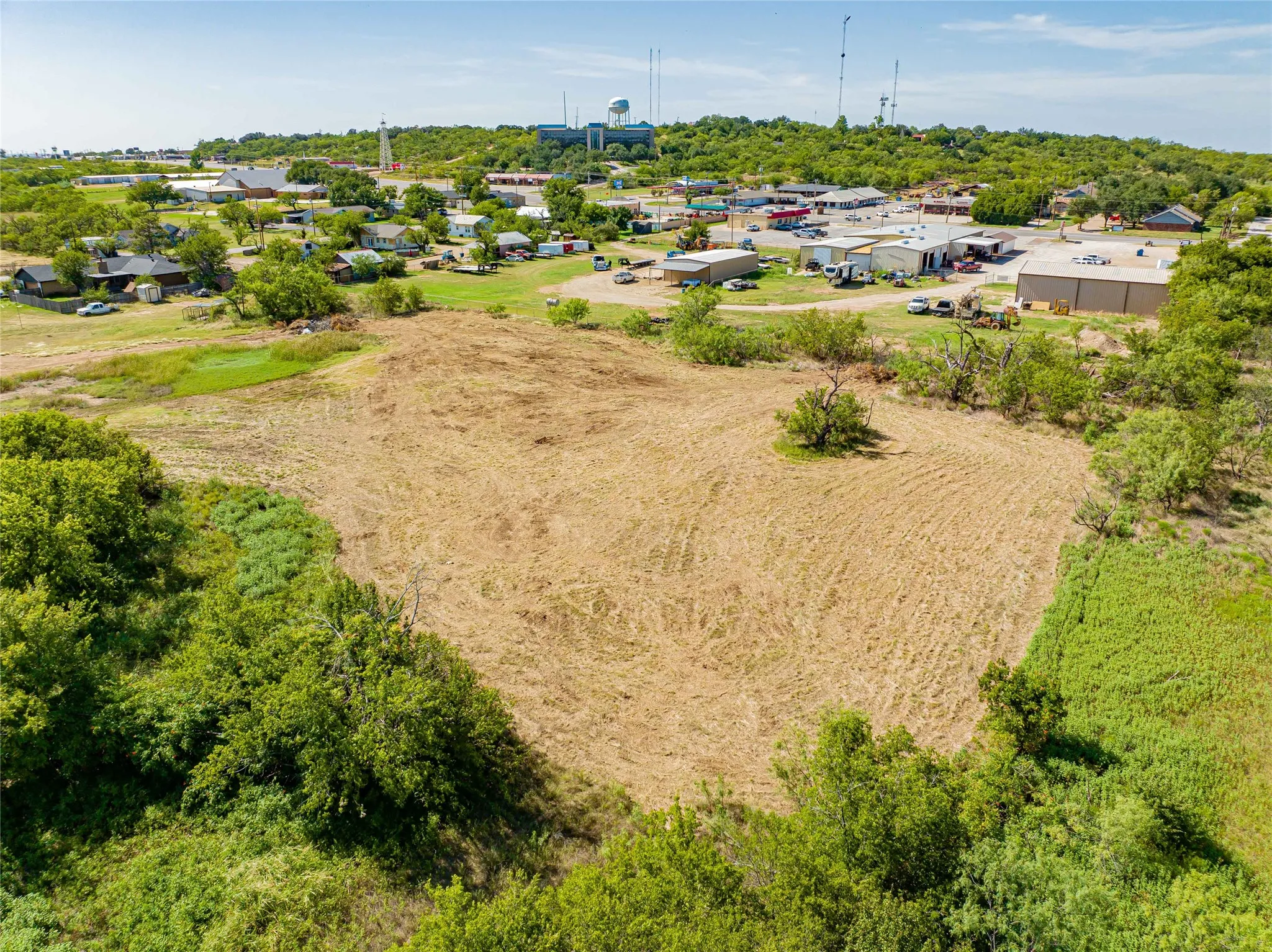 Expansive cleared lot with mature tree borders and established landscaping