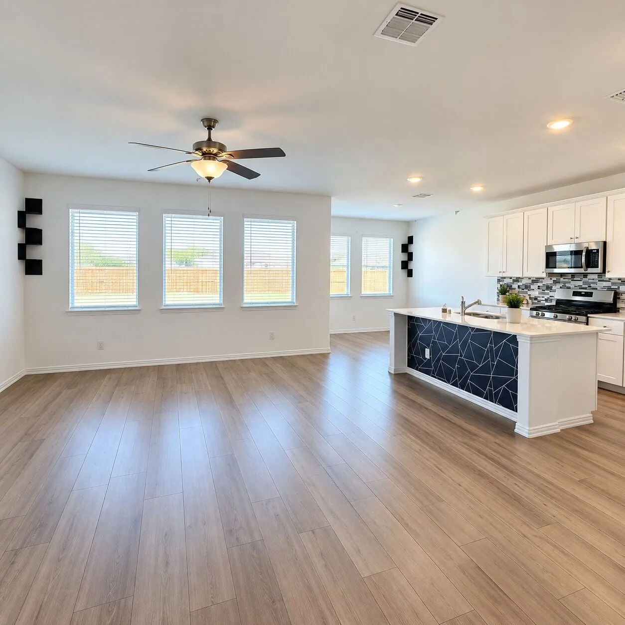 Open-concept living space featuring wood-finish flooring, recessed lighting, and a ceiling fan