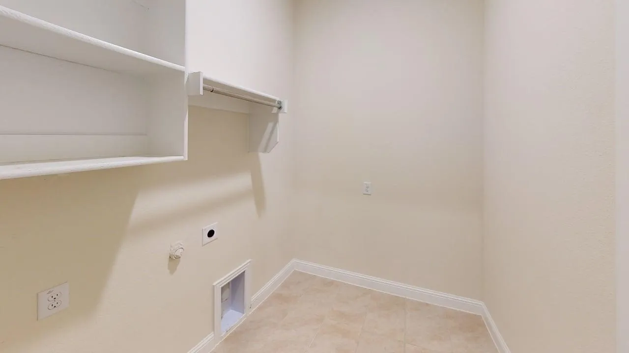 Built-in shelving, hanging rod, and tile flooring