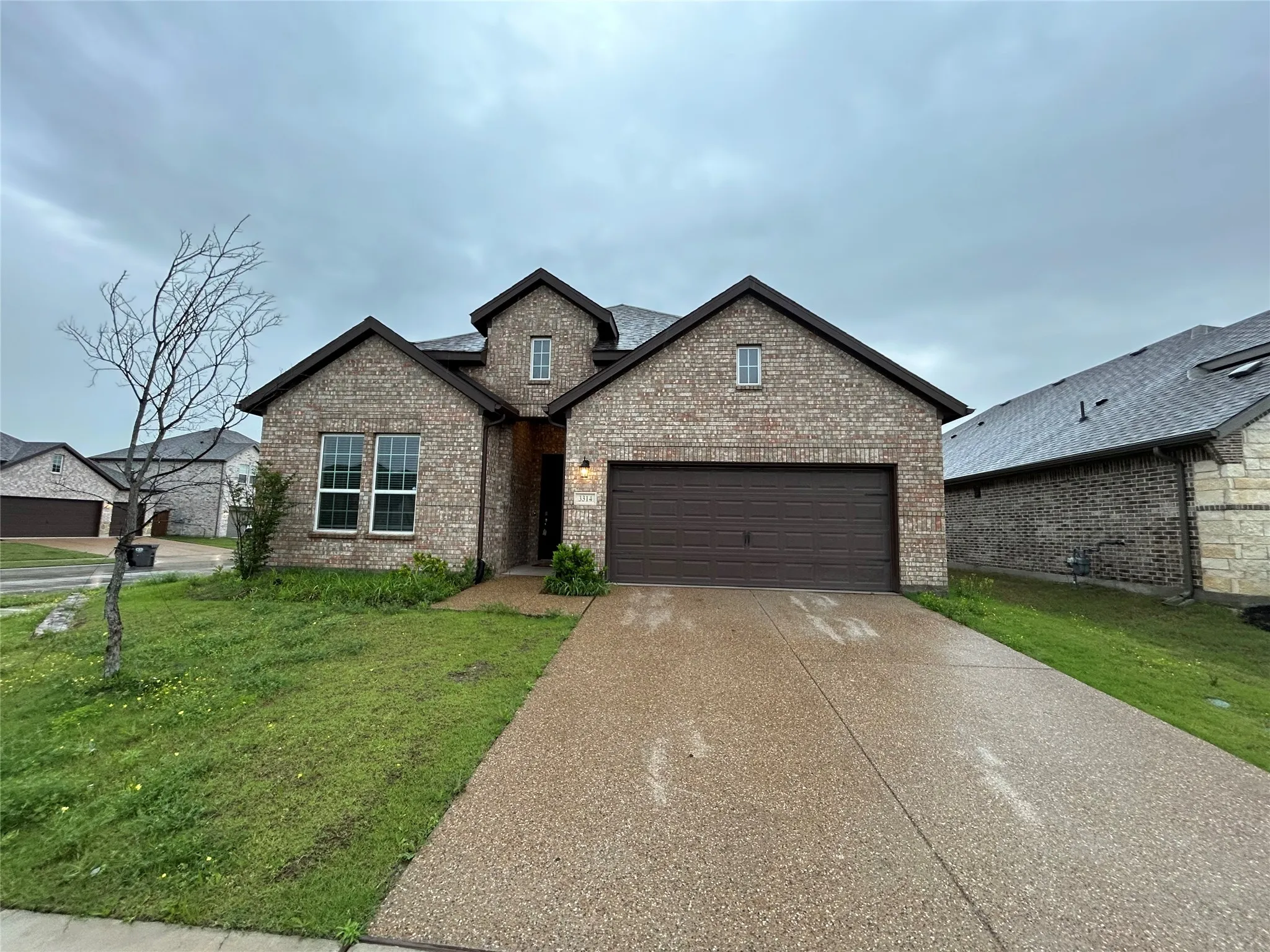 Brick and stone exterior with dual gabled rooflines and architectural detail