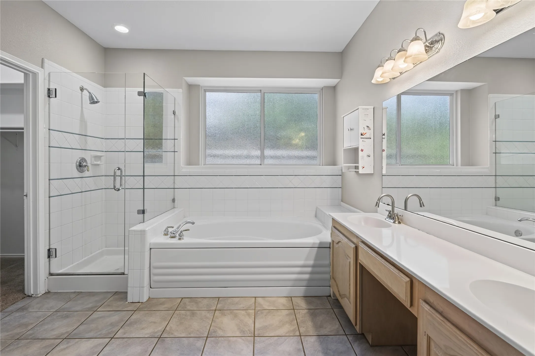 Dual vanity with integrated sinks, framed mirror, and chrome fixtures