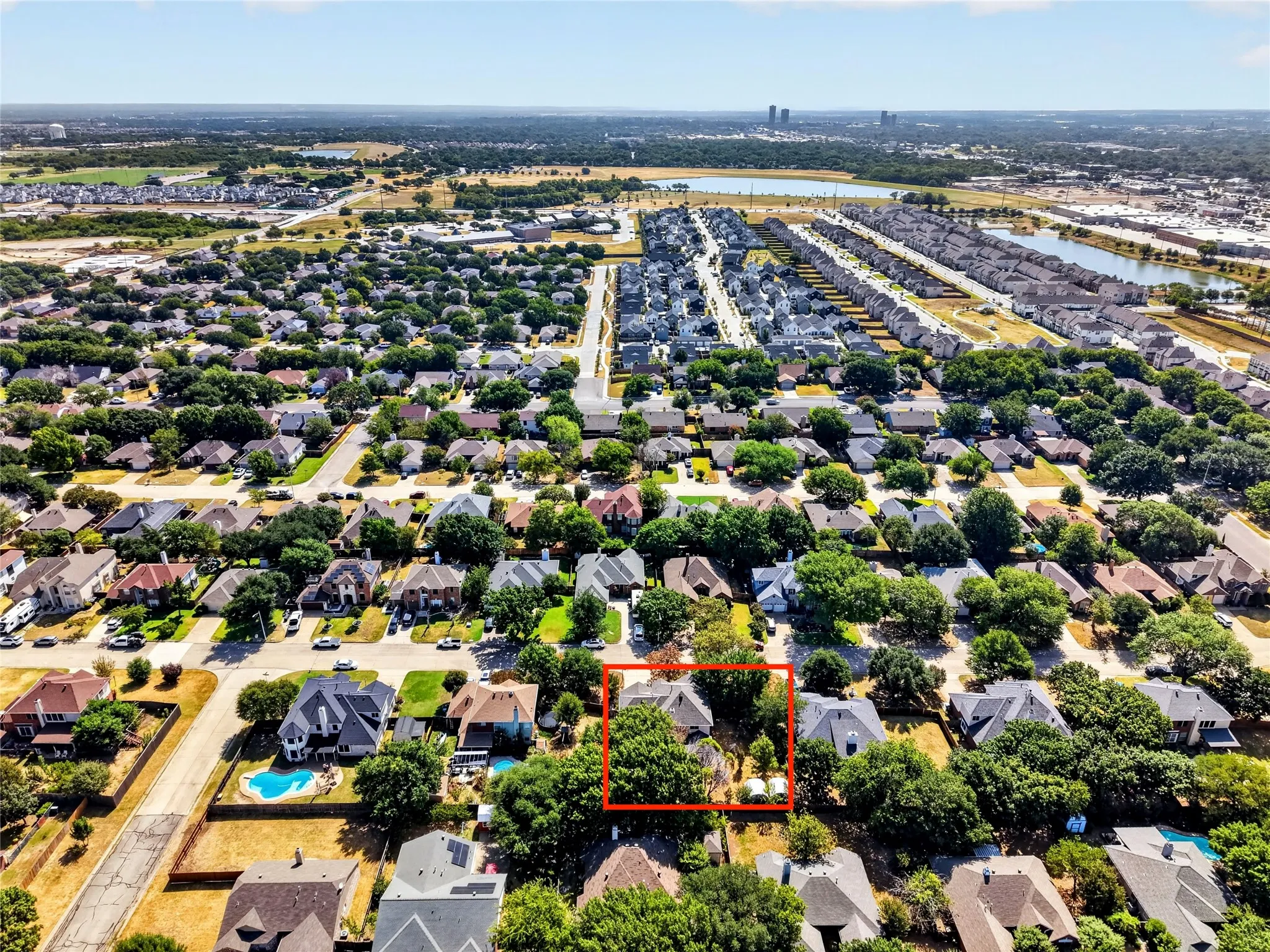 Aerial perspective of a residential neighborhood featuring mature trees and a structured street grid