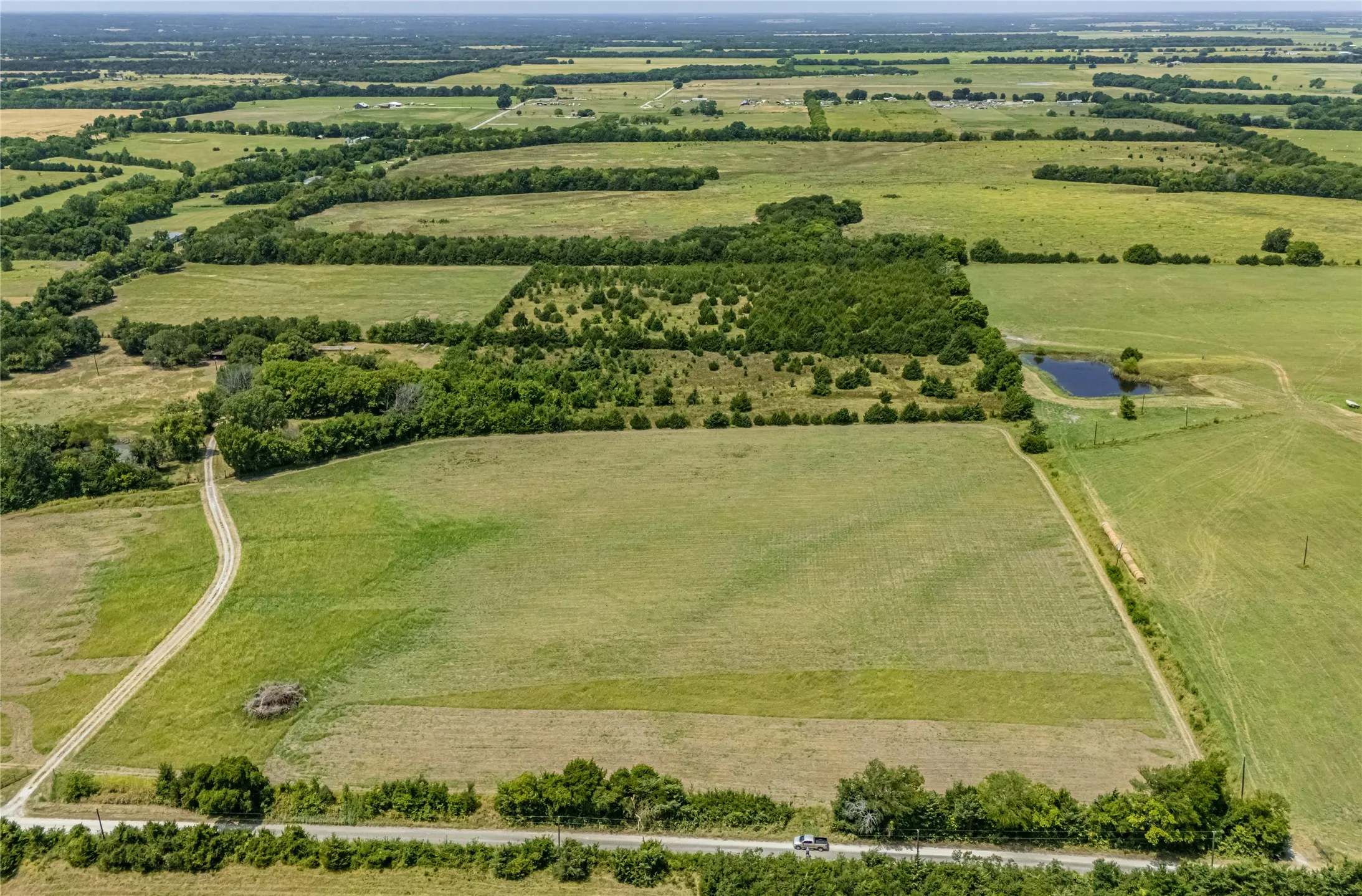 Expansive acreage, mature trees, open hay fields with an Ag Exemption.