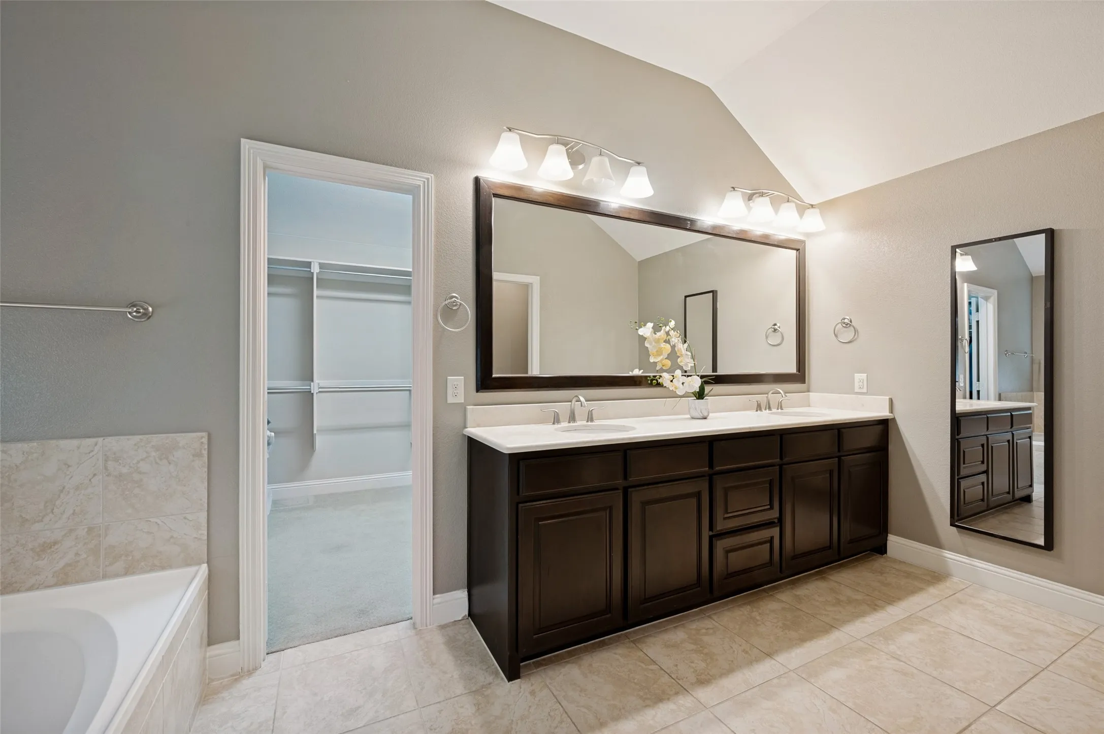 Primary bath with dual sinks and generous vanity space.