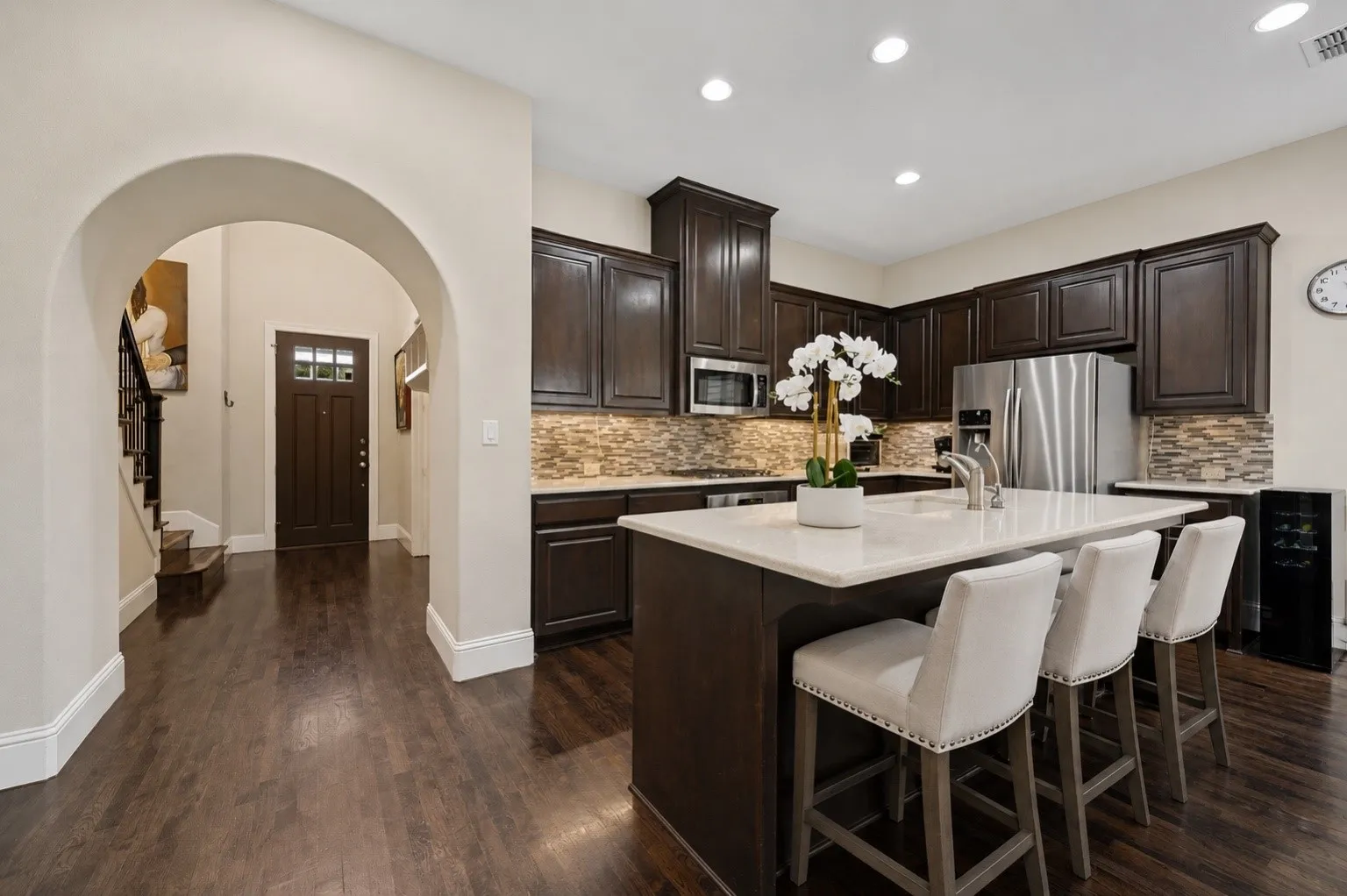 Open kitchen with oversized island and abundant cabinetry.