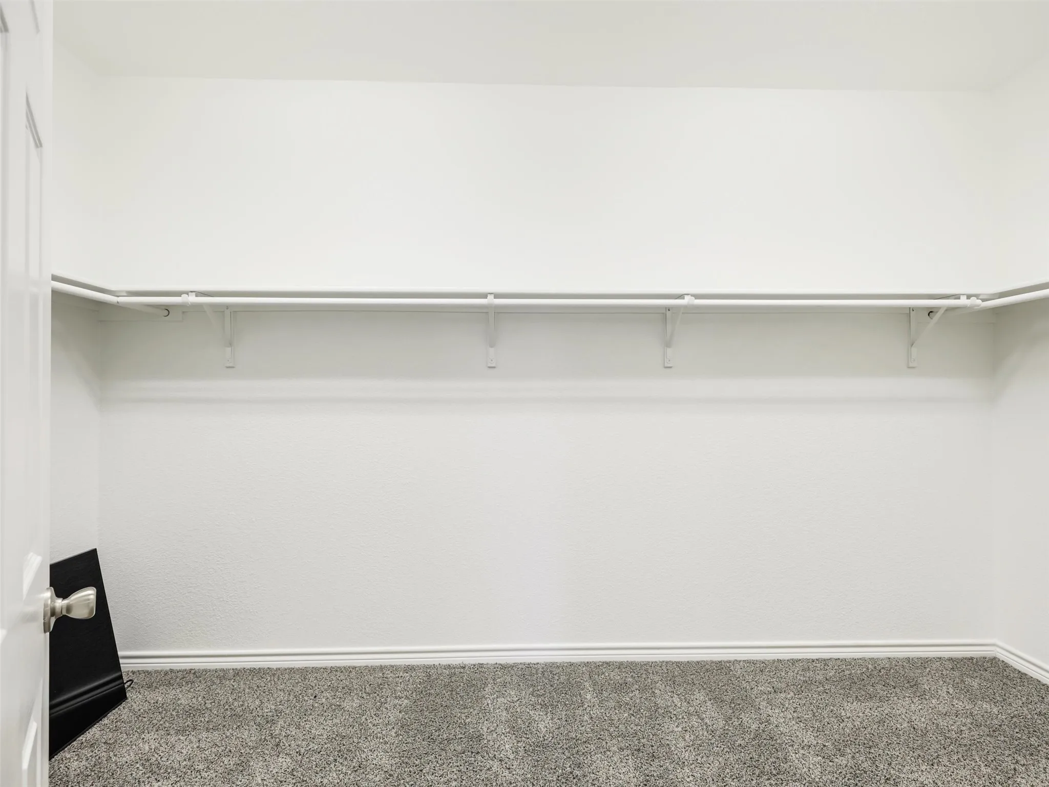 Oversized walk-in closet provides abundant hanging and storage space, conveniently located just off the primary bathroom.
