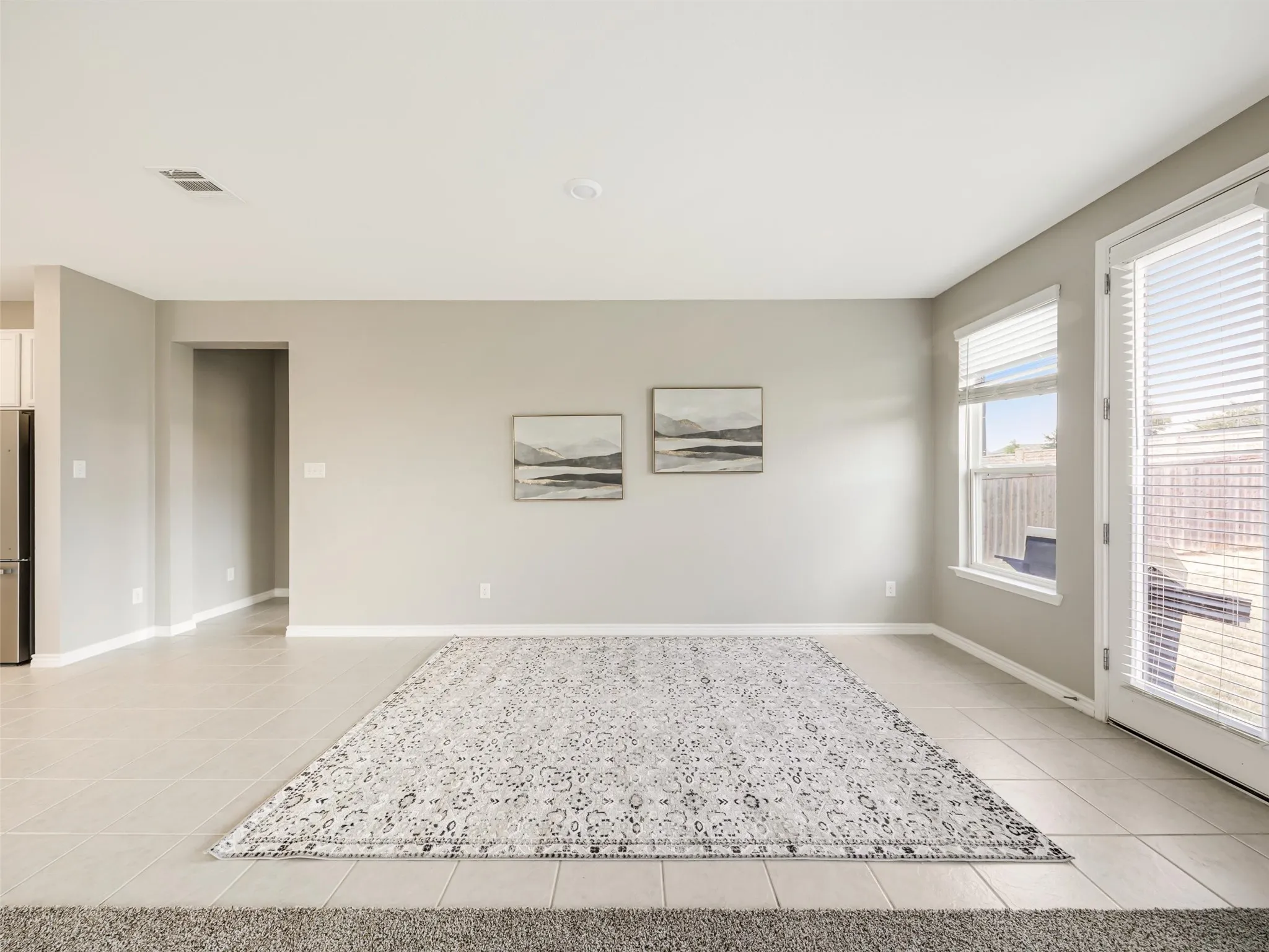 Flexible dining area offers easy access to the kitchen and backyard, with ample space for casual meals, entertaining, or a secondary sitting area.