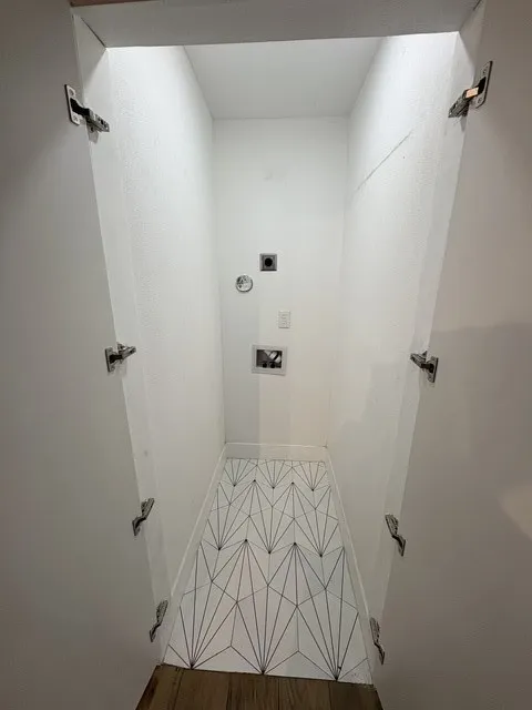 Laundry closet for stack washer and dryer.