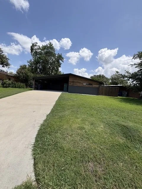 Front entry driveway to a 2 car carport.