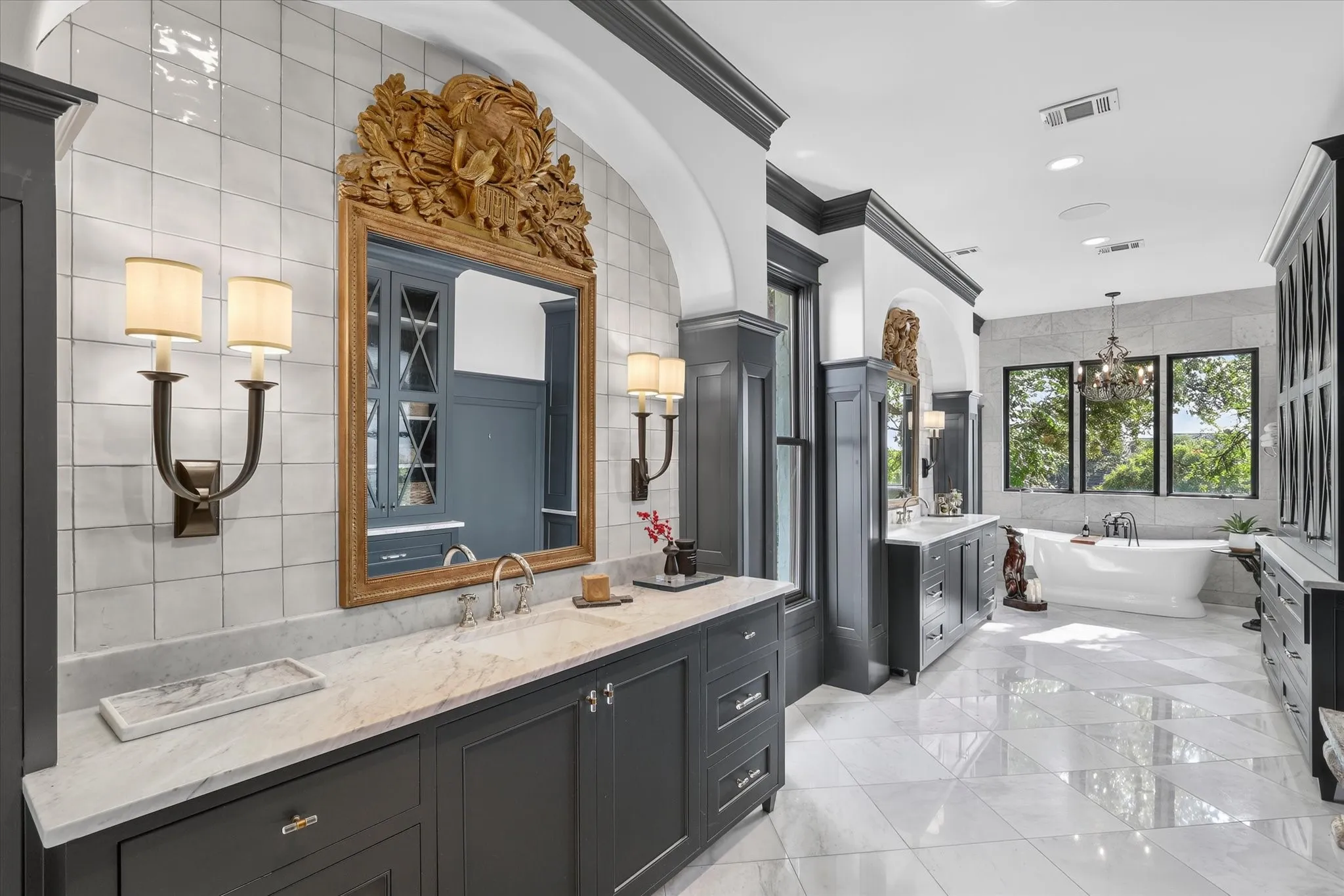 Spa-inspired primary bath pairs custom cabinetry, marble surfaces and sophisticated architectural detailing.