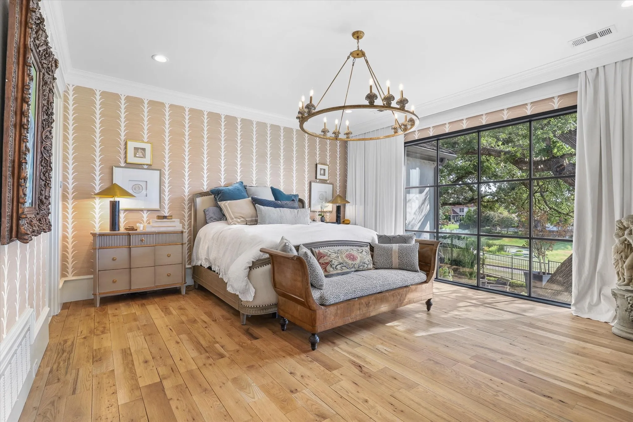 Serene primary suite with hardwood floors, beautiful natural light and tranquil views of the surrounding landscape.