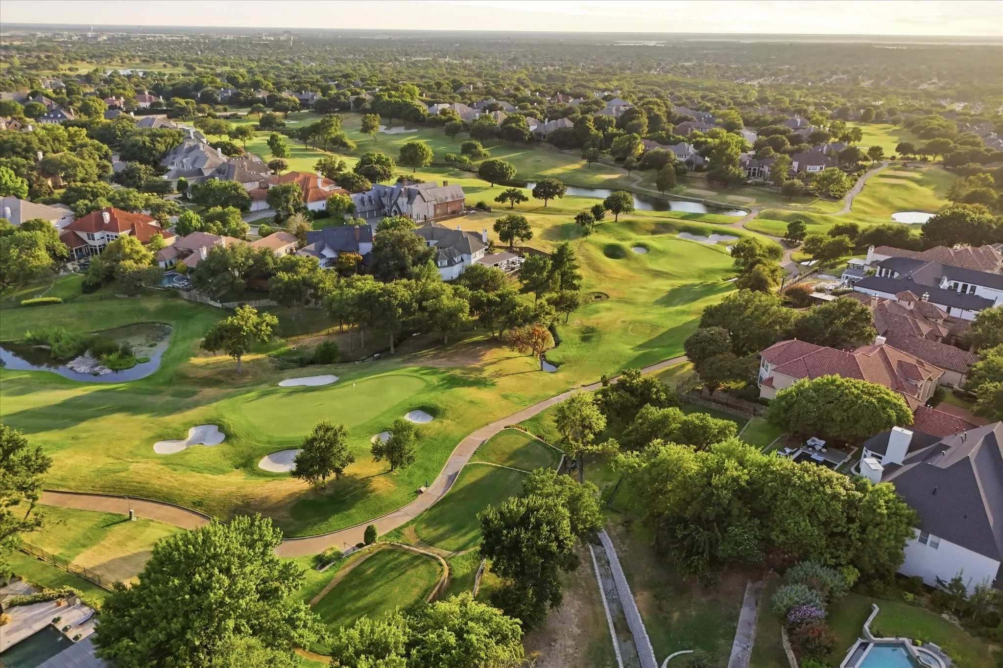 A spectacular aerial perspective showcases the surrounding golf course and lush Stonebriar Village setting.