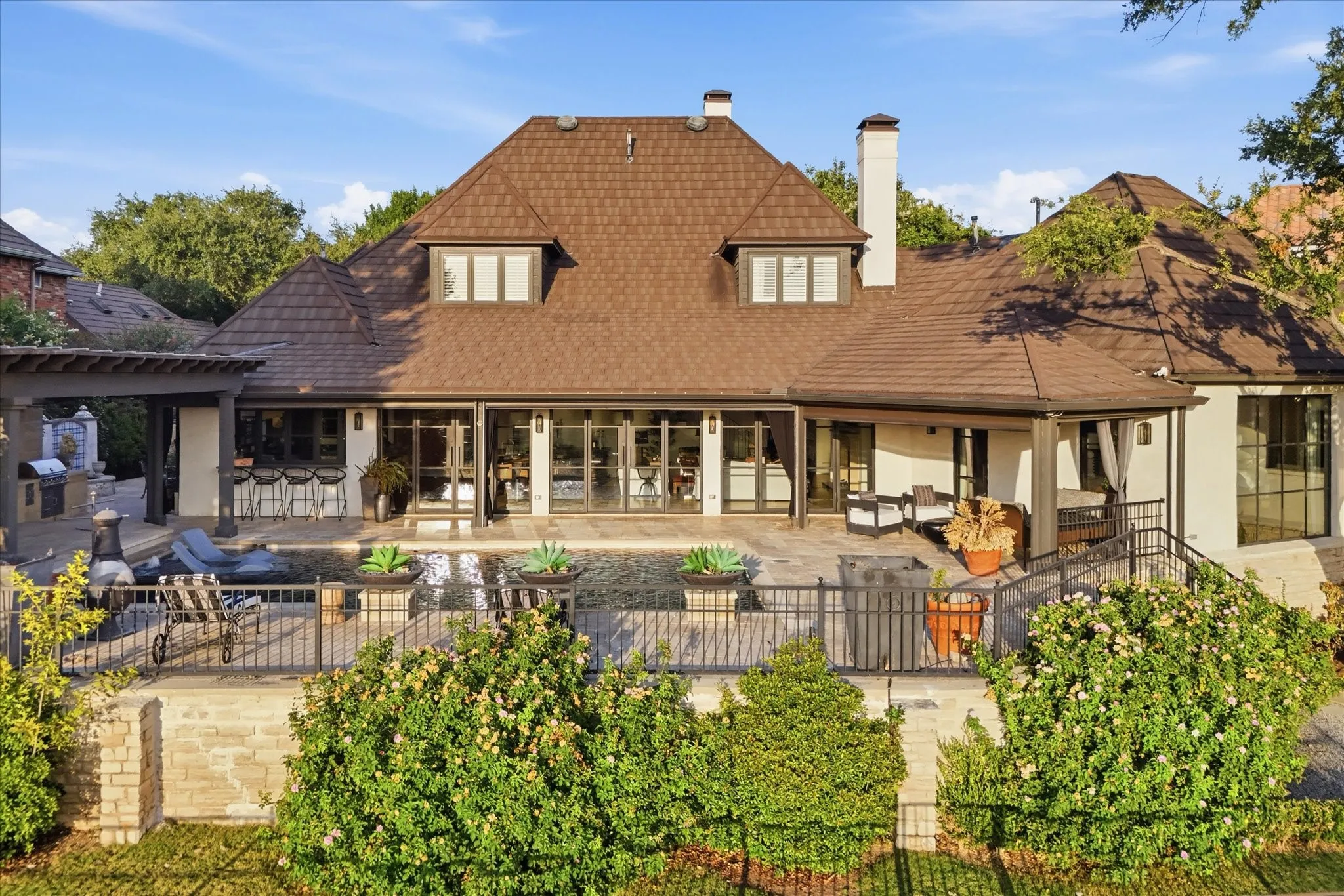 The beautifully reimagined residence wraps around its outdoor living spaces, creating exceptional views and connectivity from inside the home.