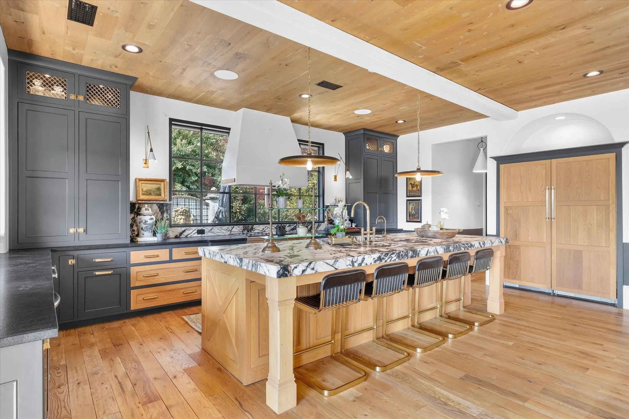 An impressive island provides abundant prep space and seating while anchoring the open-concept kitchen.