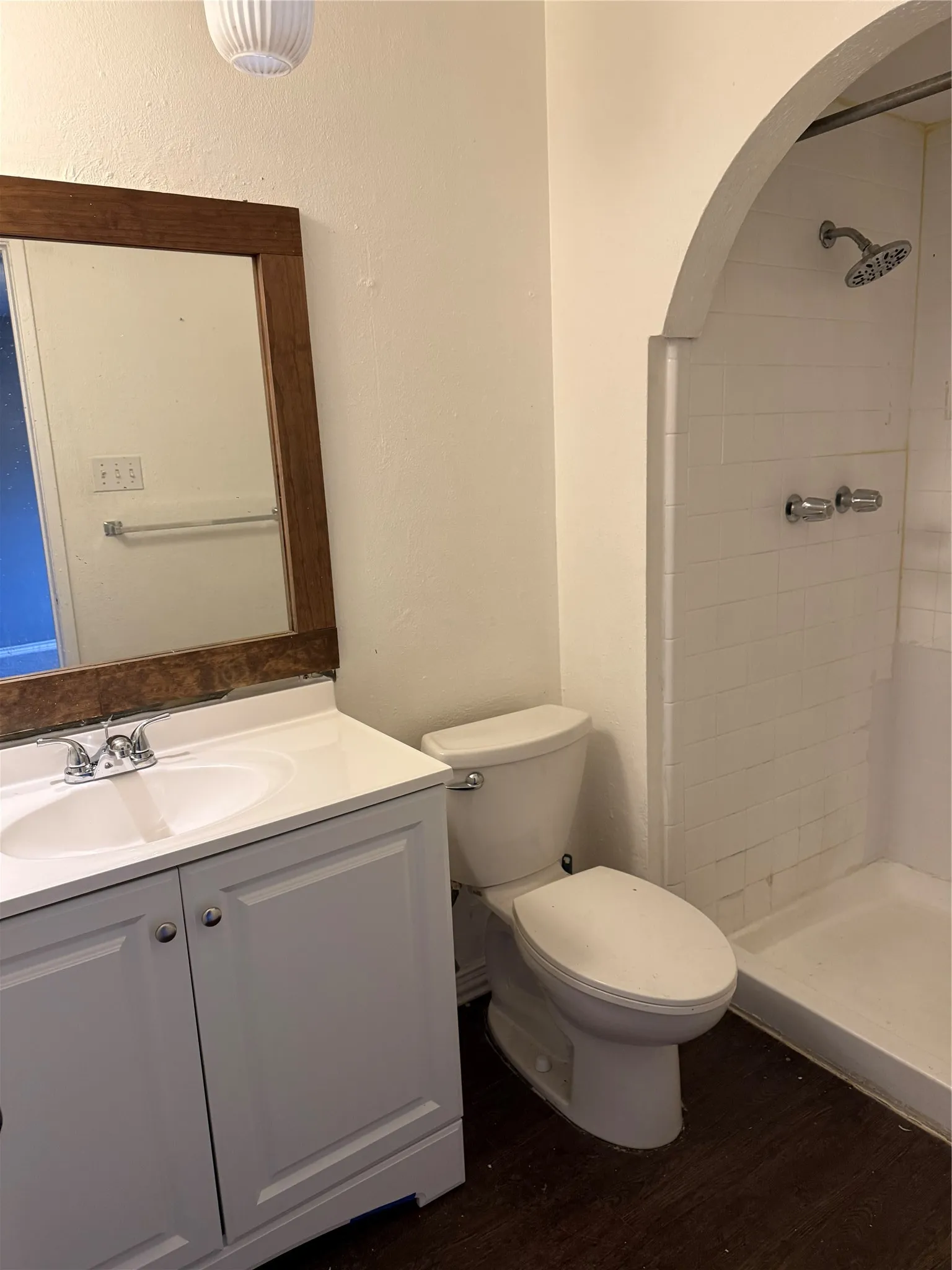 White vanity with dual cabinet storage, white sink, and chrome faucet