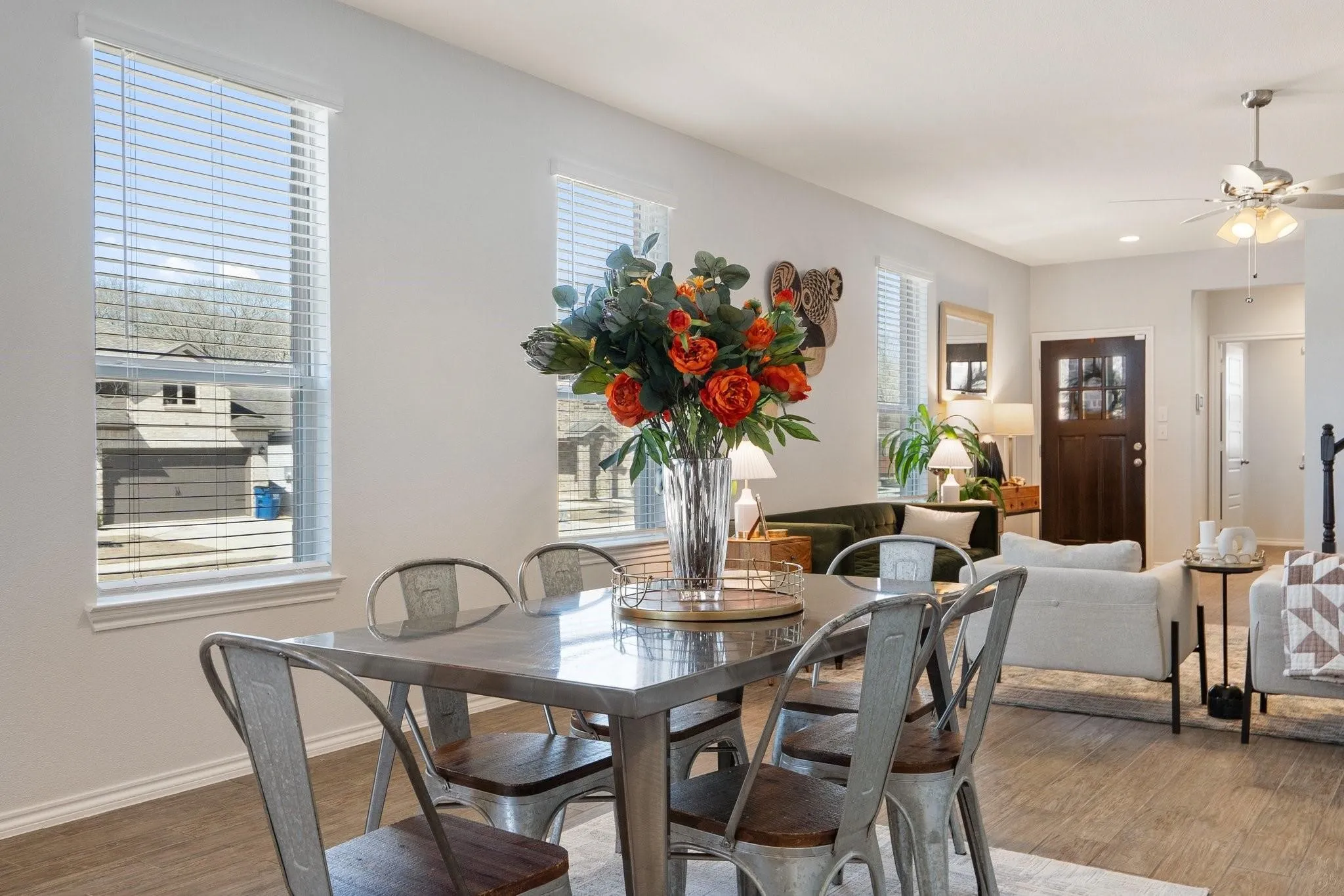 Dining area with baseboards, a ceiling fan, and light wood finished floors