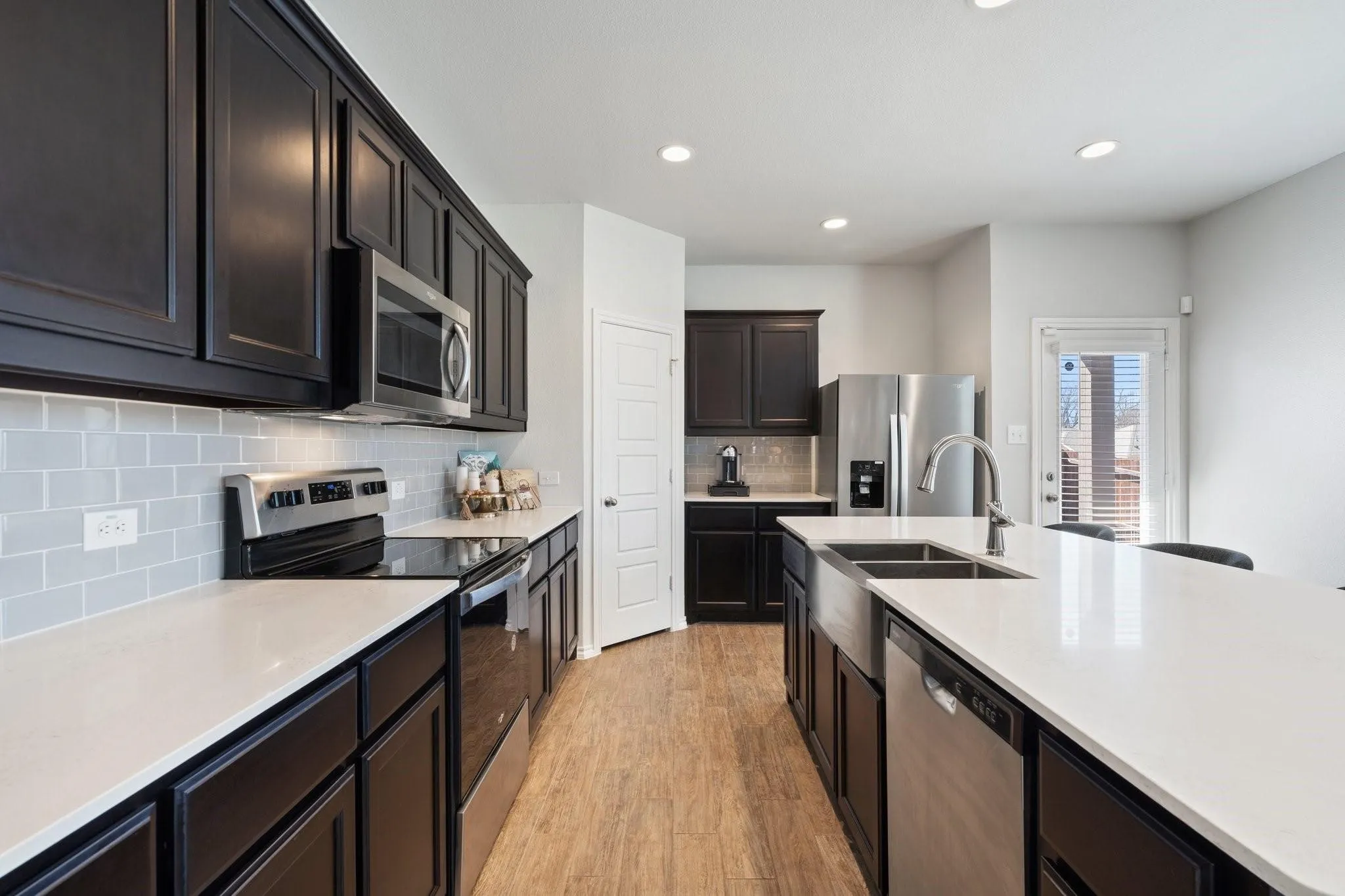 Kitchen with light countertops, recessed lighting, light wood-style floors, and appliances with stainless steel finishes