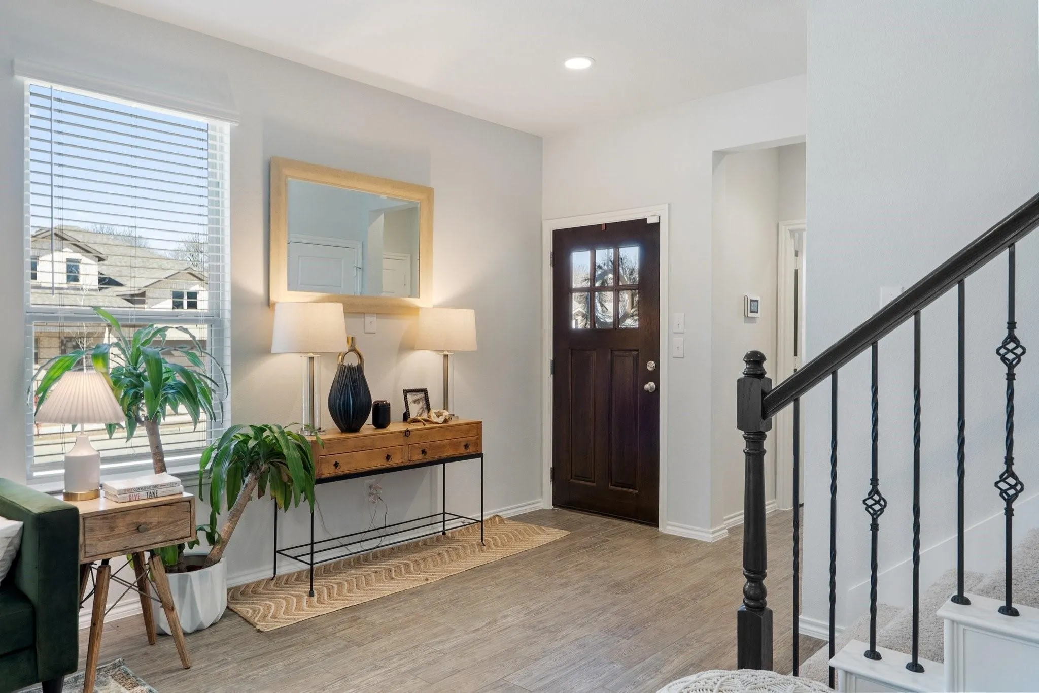 Entrance foyer with baseboards, wood finished floors, recessed lighting, and stairs