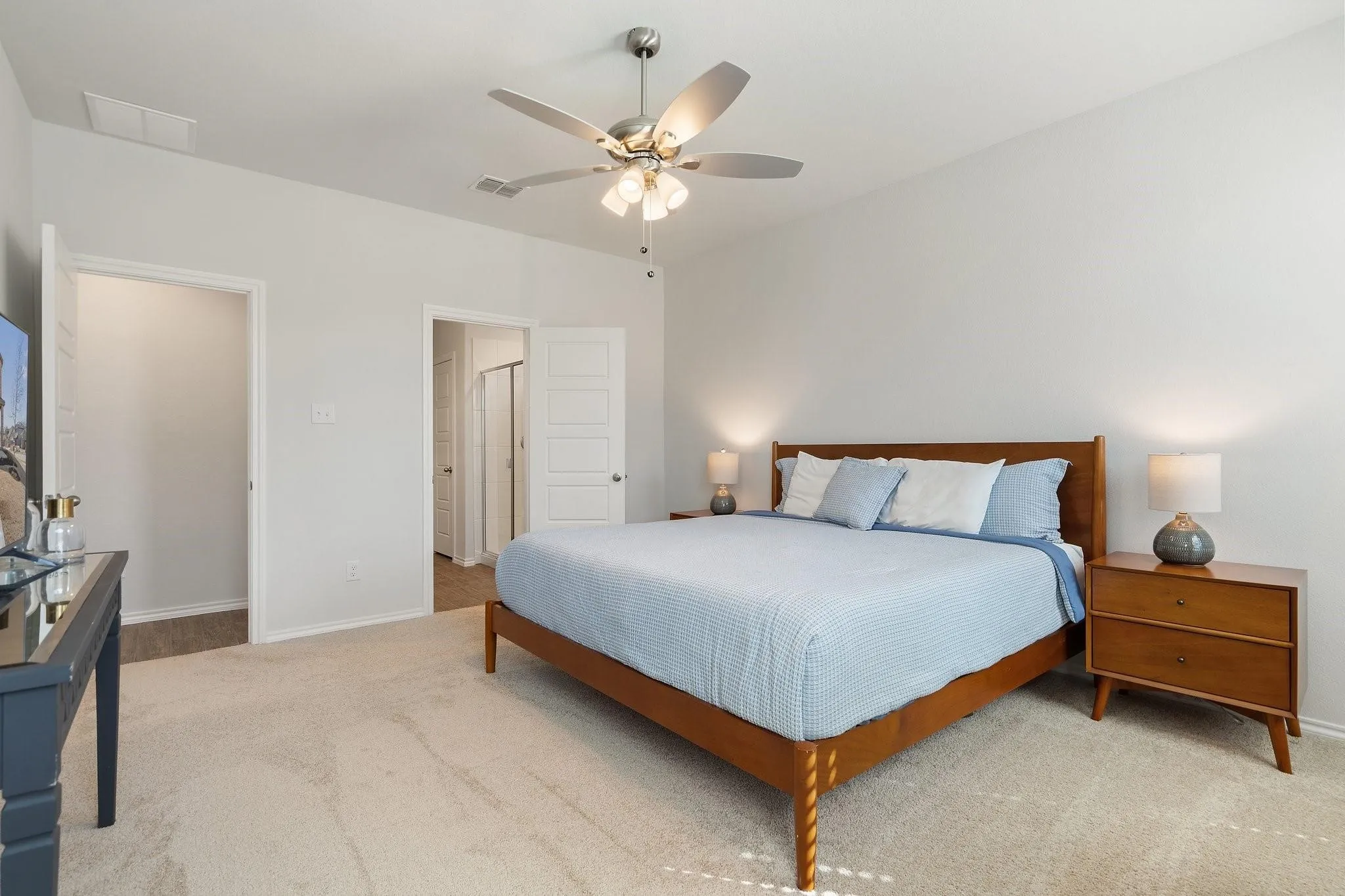 Carpeted bedroom featuring baseboards, a ceiling fan, and visible vents