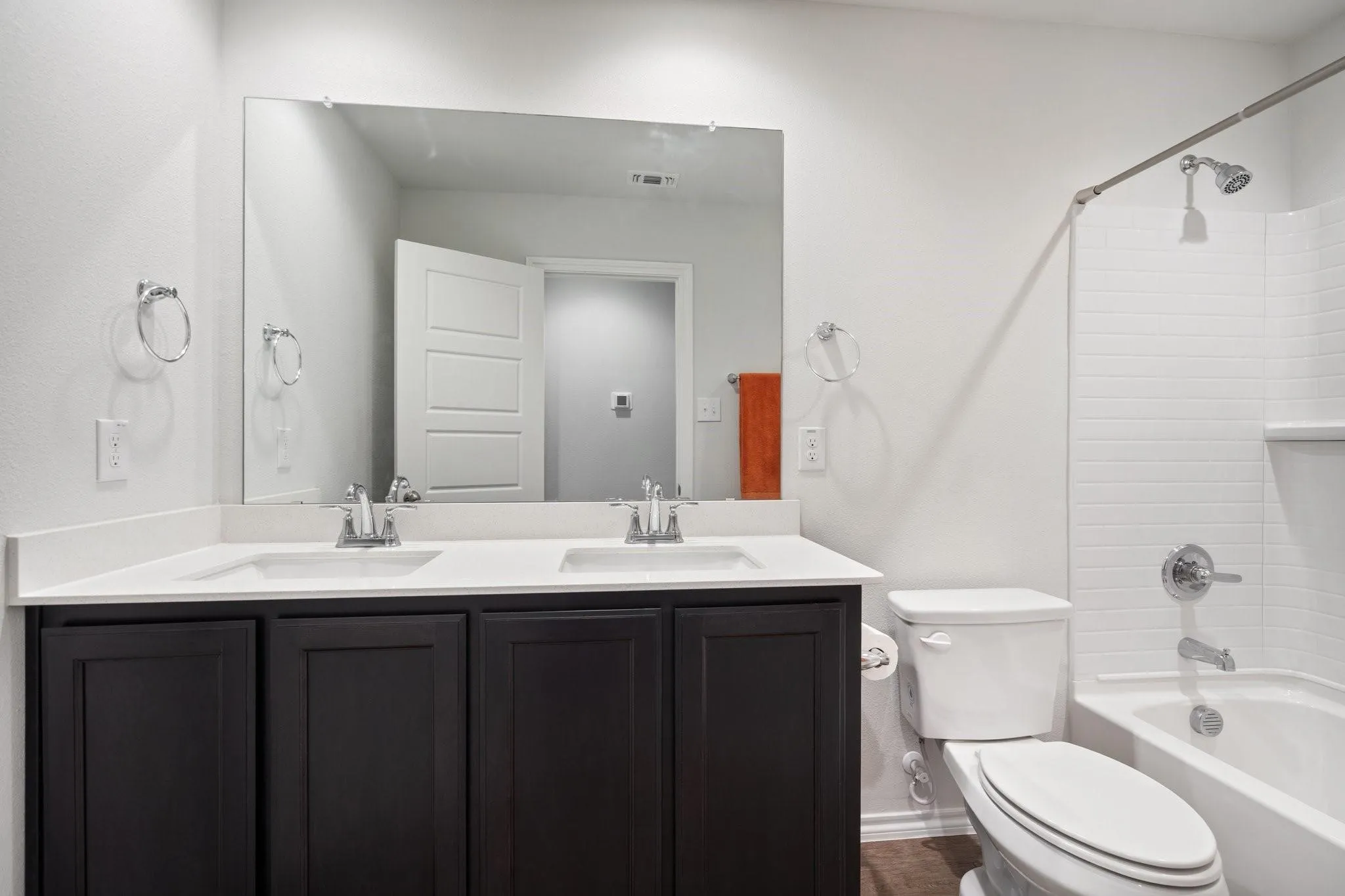 Full bath with toilet, a sink, visible vents, and double vanity