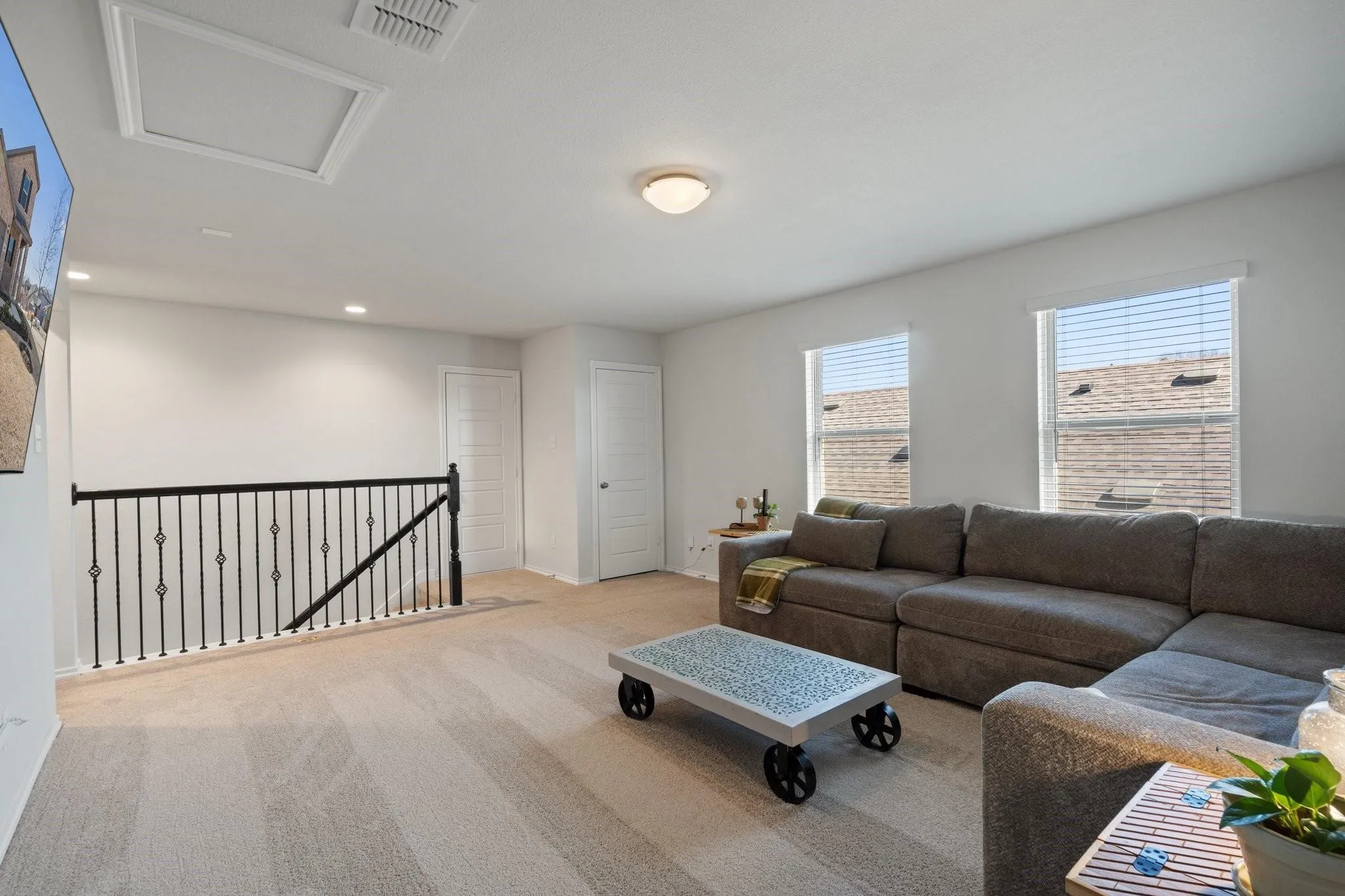Living room featuring attic access, carpet, baseboards, visible vents, and recessed lighting