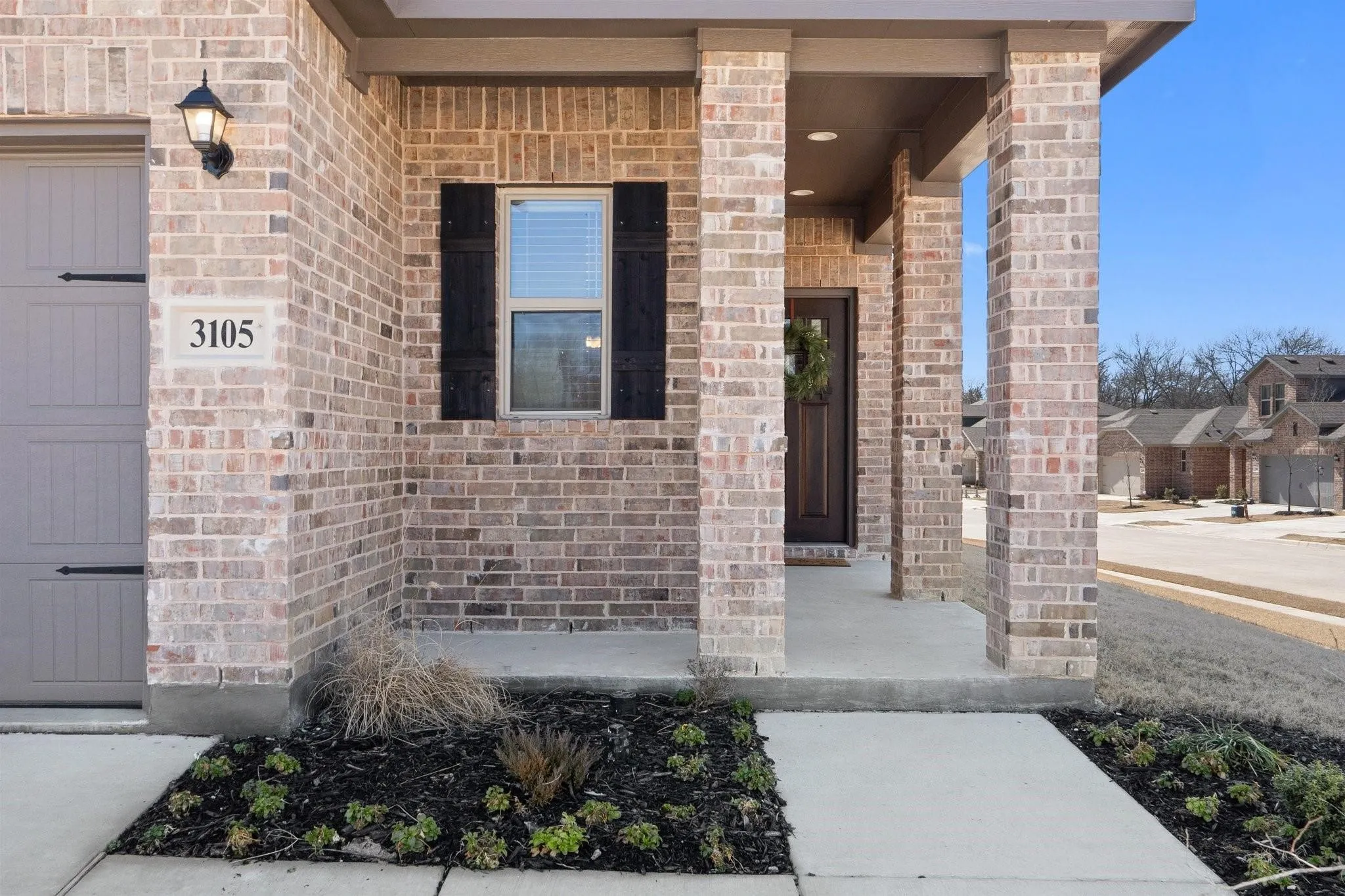 View of exterior entry featuring covered porch