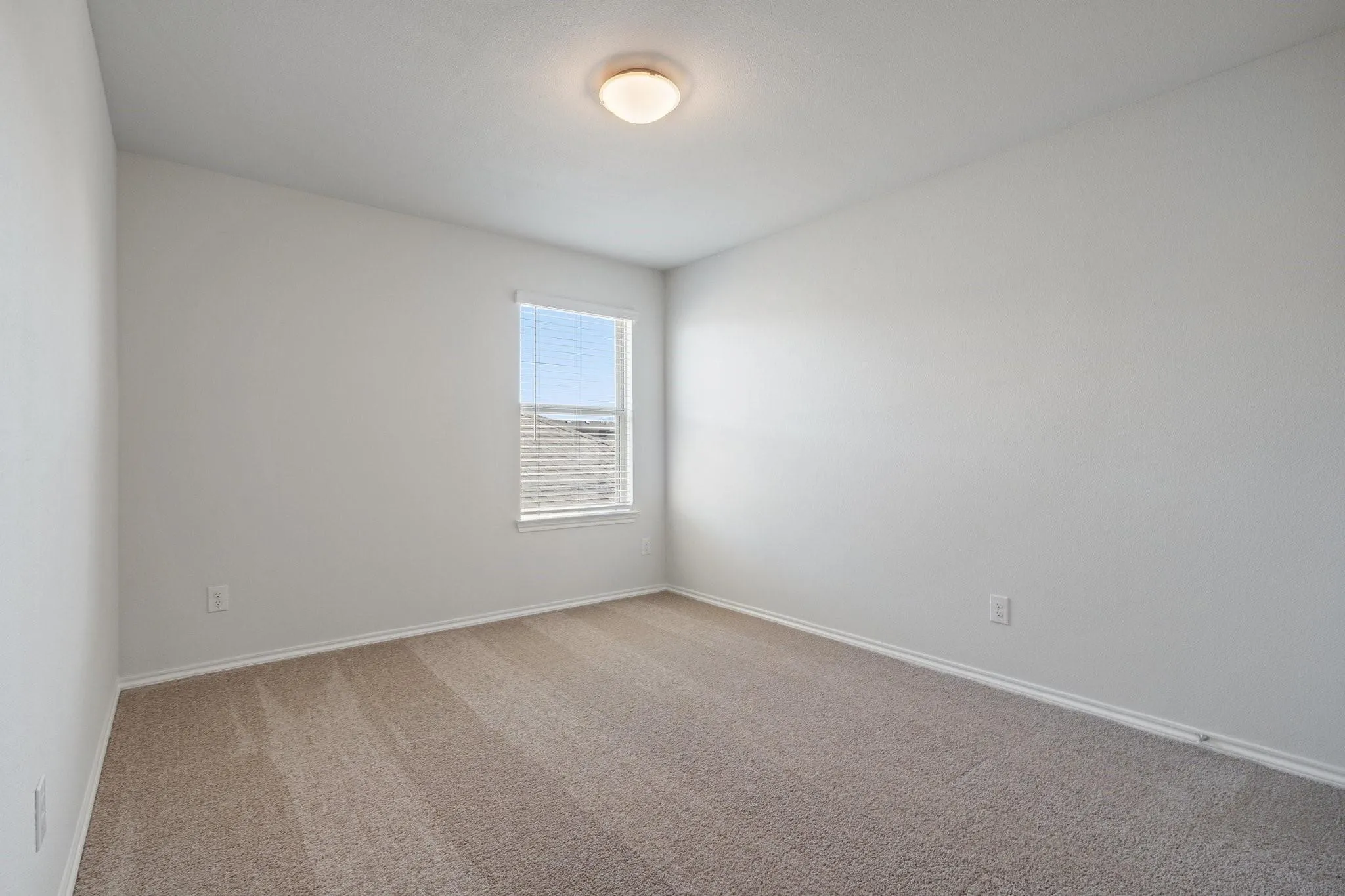 Empty room featuring carpet floors and baseboards
