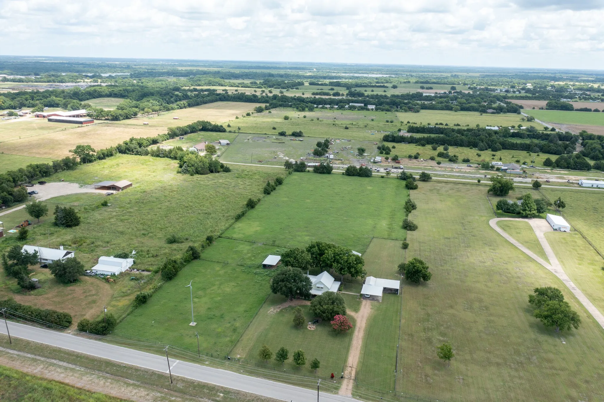 Expansive acreage with multiple structures, including residential buildings and outbuildings