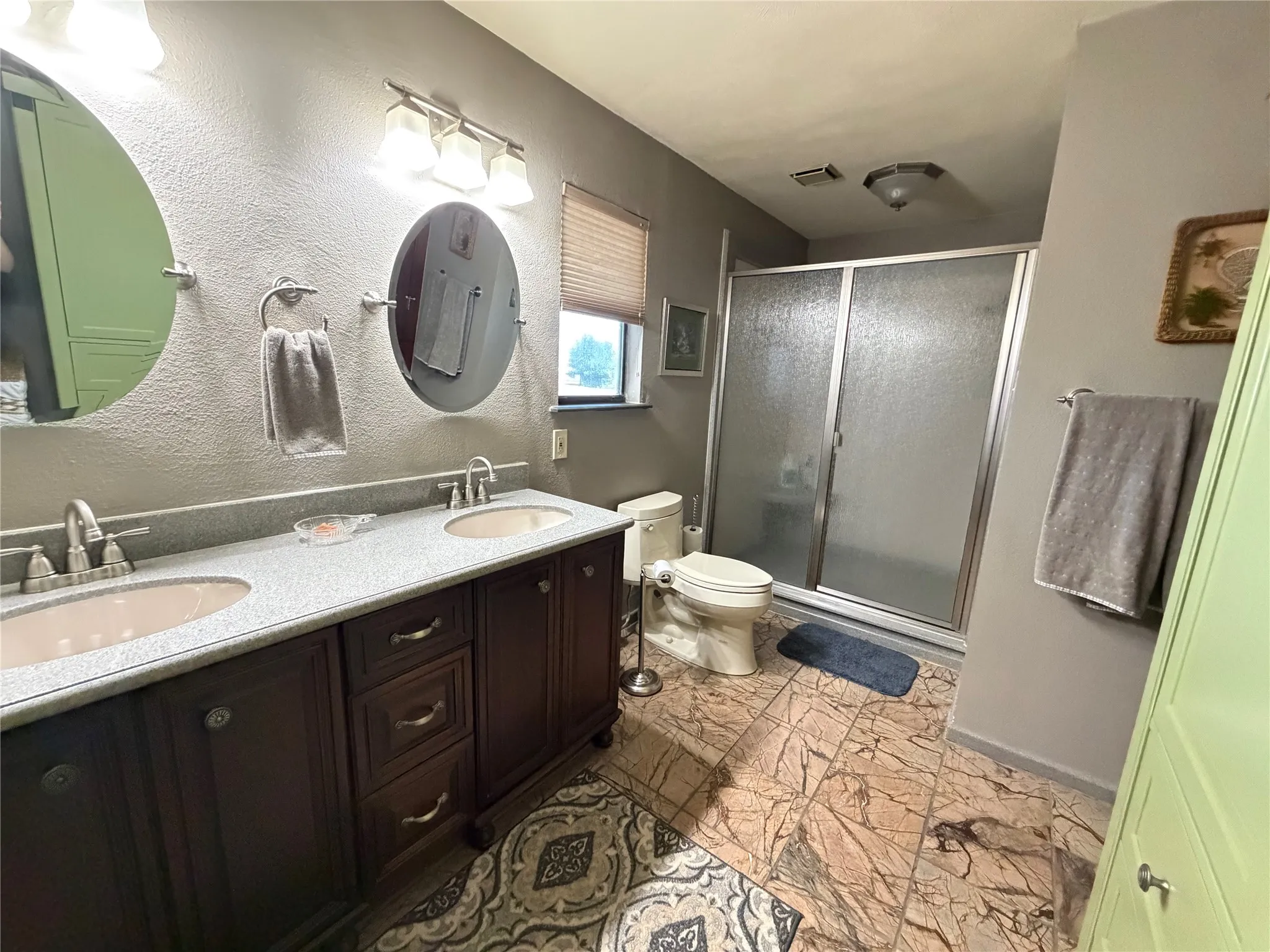Dual vanity with undermount sinks and dark wood-finish cabinetry